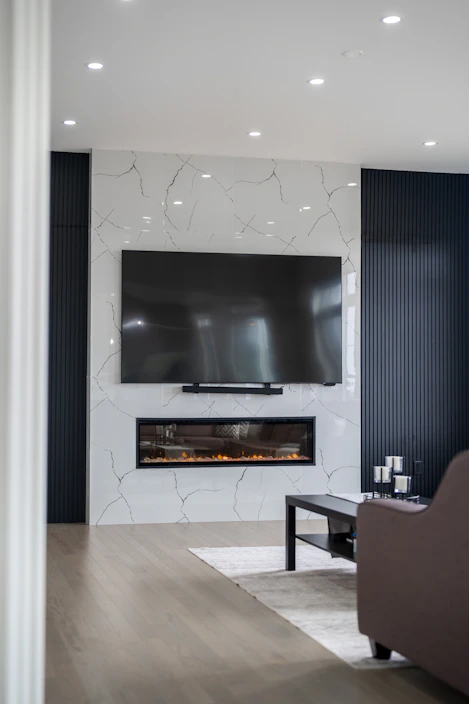 Modern living room with fireplace and large television.