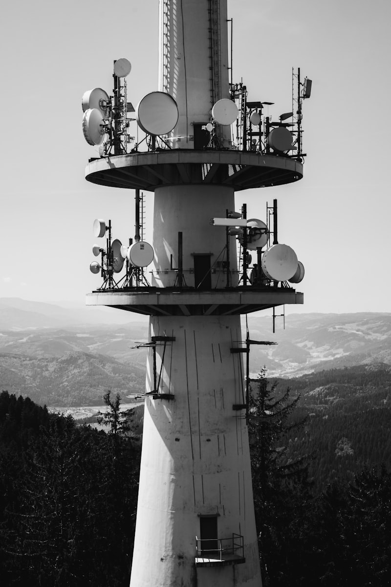 Telecommunications tower with surveillance antennas