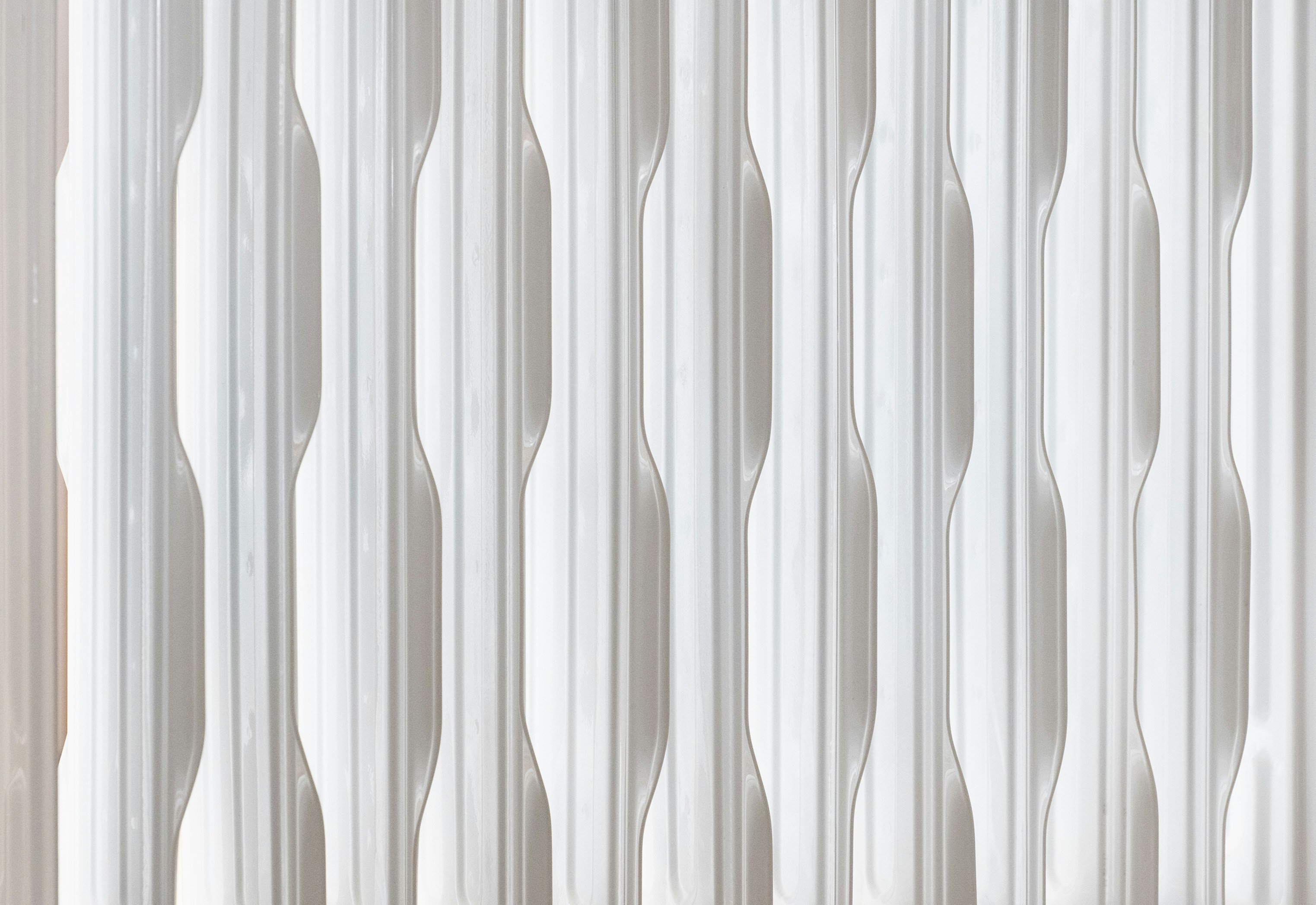 Close-up of a white radiator with vertical fins