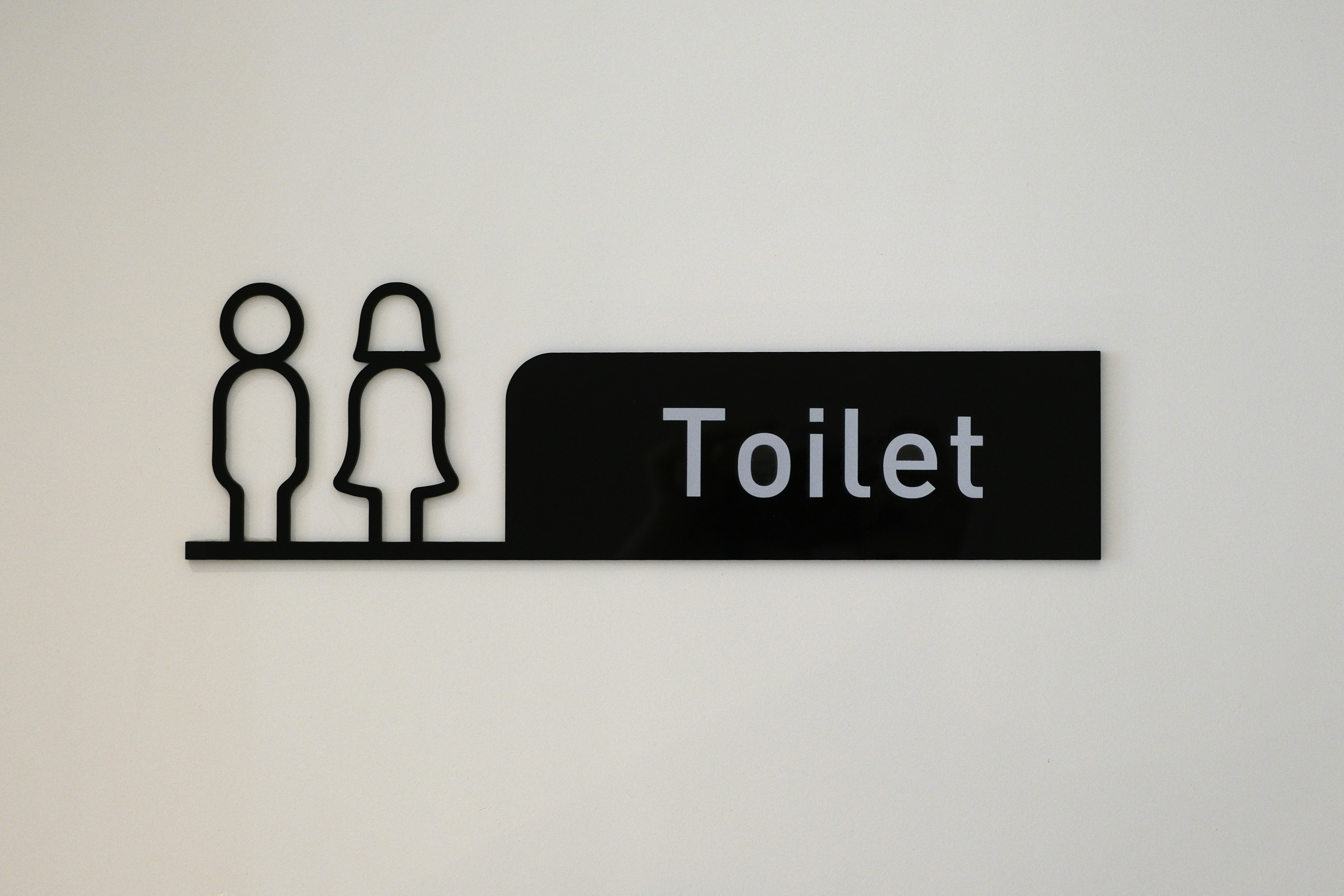 Toilet sign with male and female figures