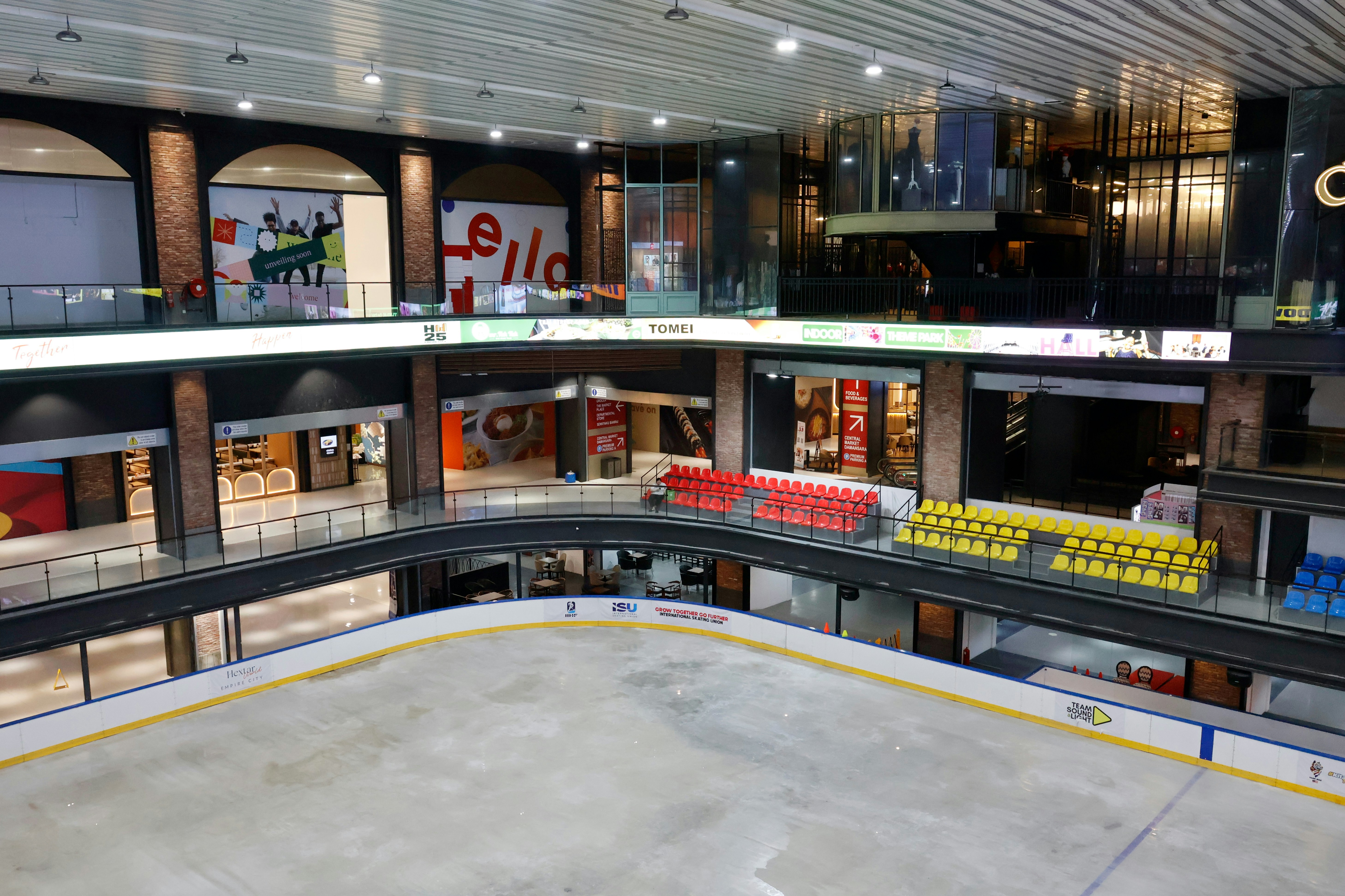 Indoor ice rink with surrounding shops and upper-level shops