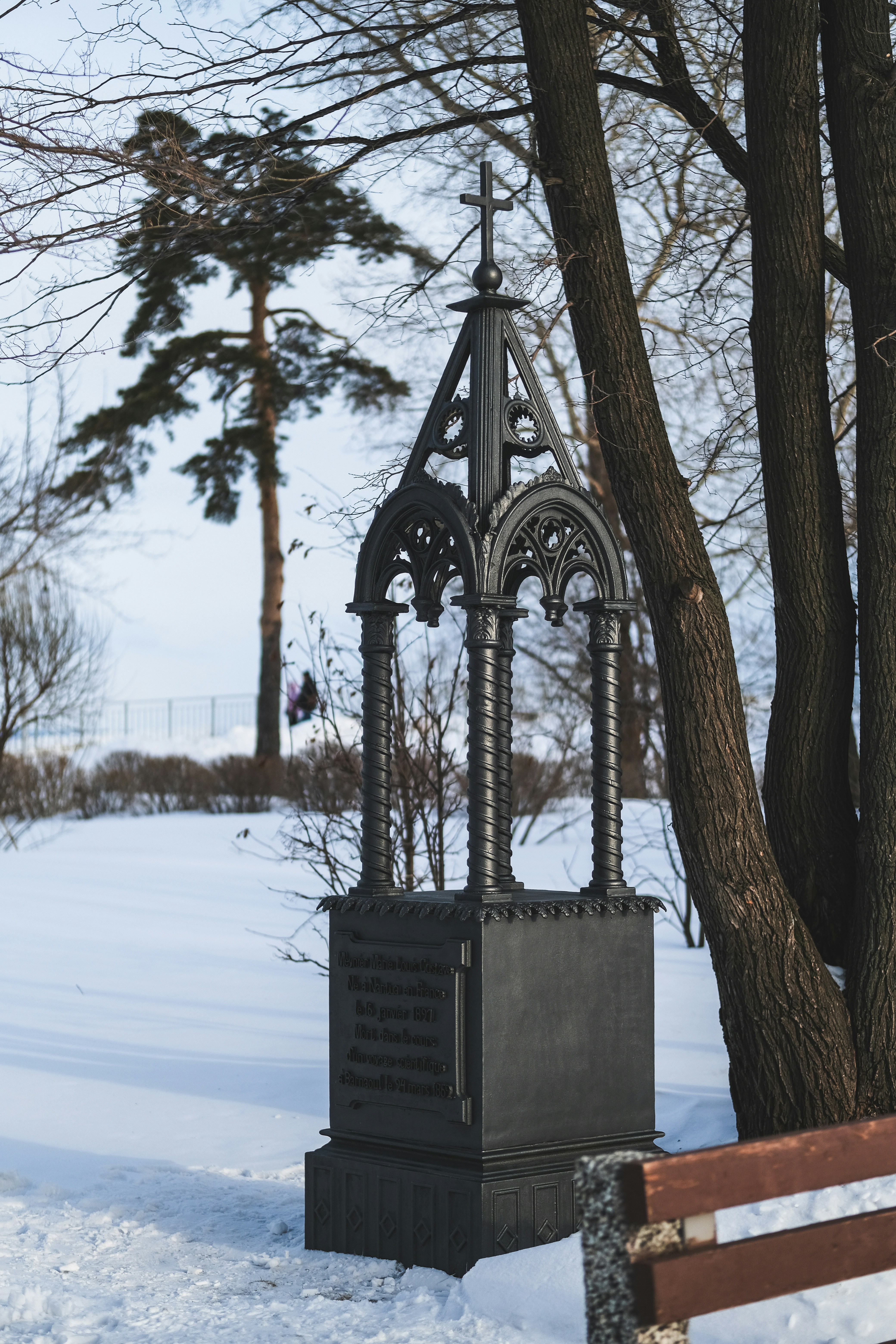 Ornate monument in a snowy park setting