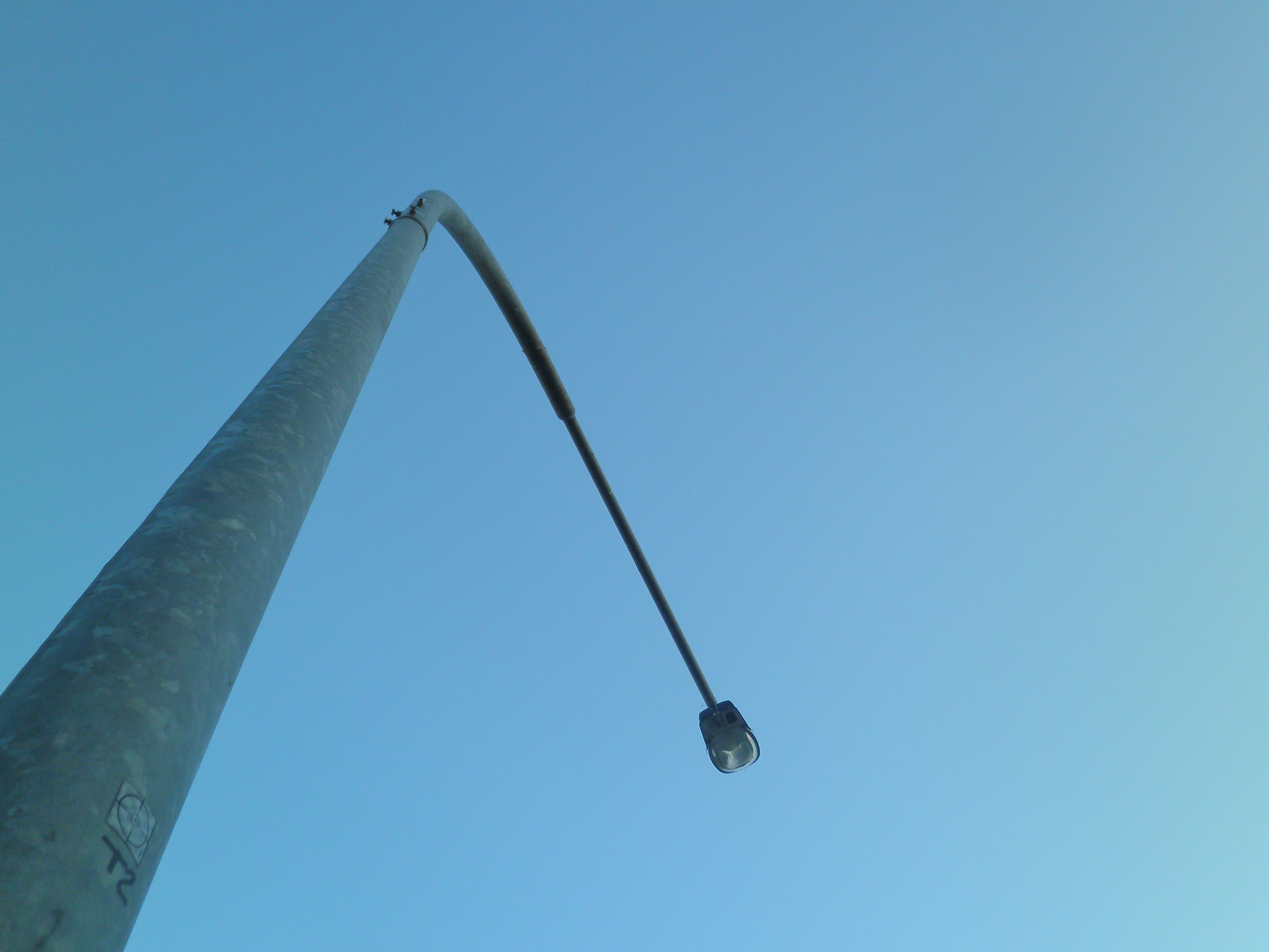 Streetlight pole against a clear blue sky