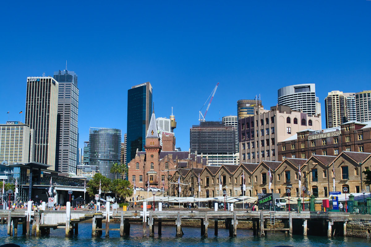 Historic buildings at The Rocks beside the modern Sydney skyline and harbour