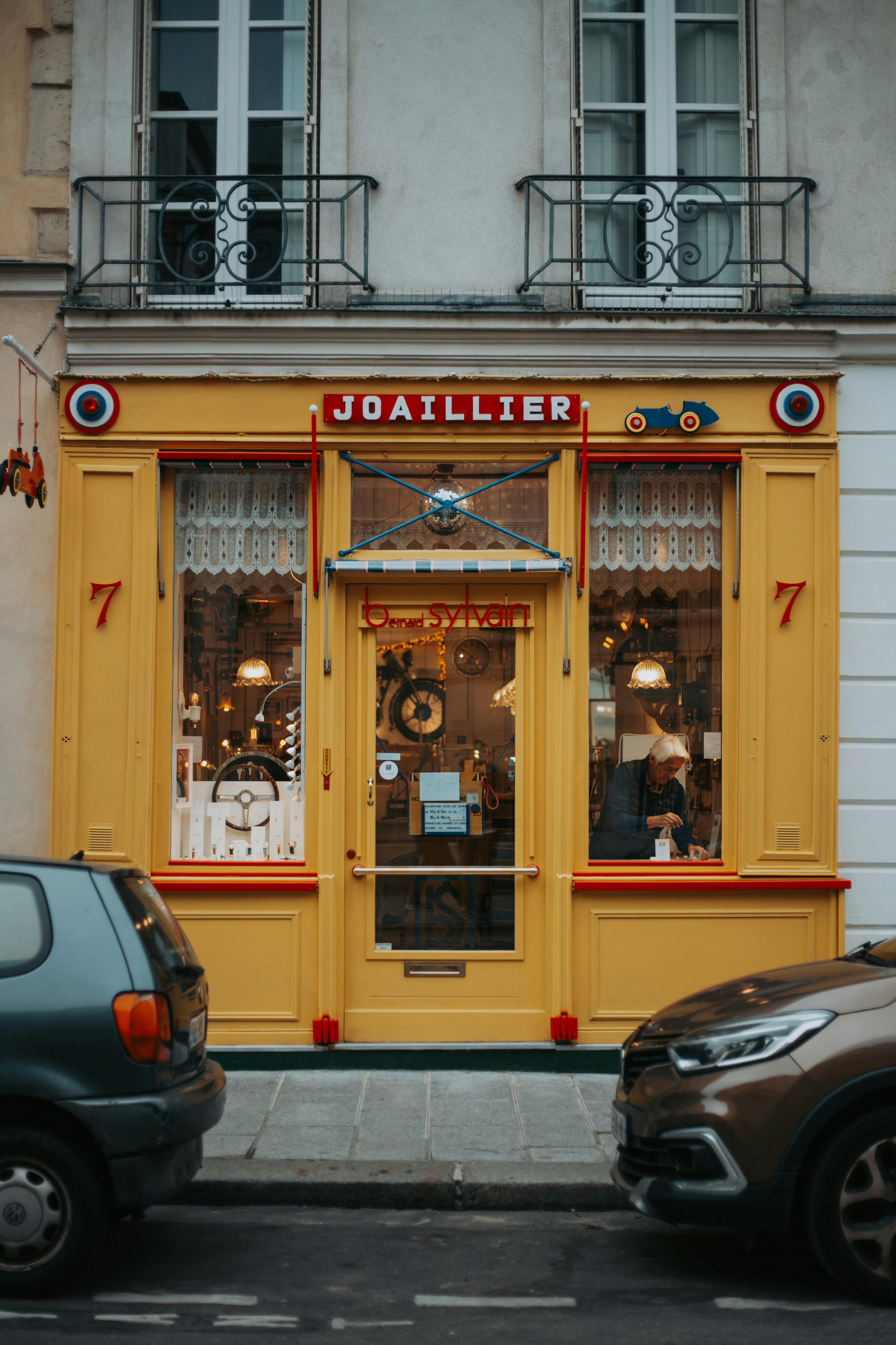 Yellow storefront with "joaillier" sign and display windows.