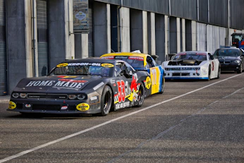 Race cars lined up on asphalt track