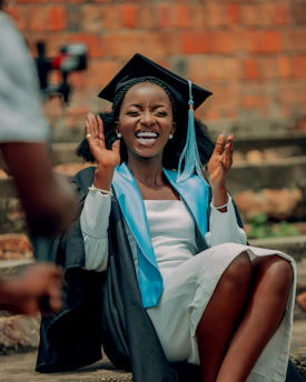 A happy graduate in cap and gown celebrates achievement