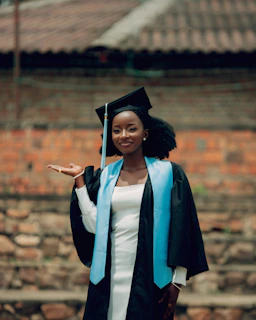 A smiling graduate in cap and gown