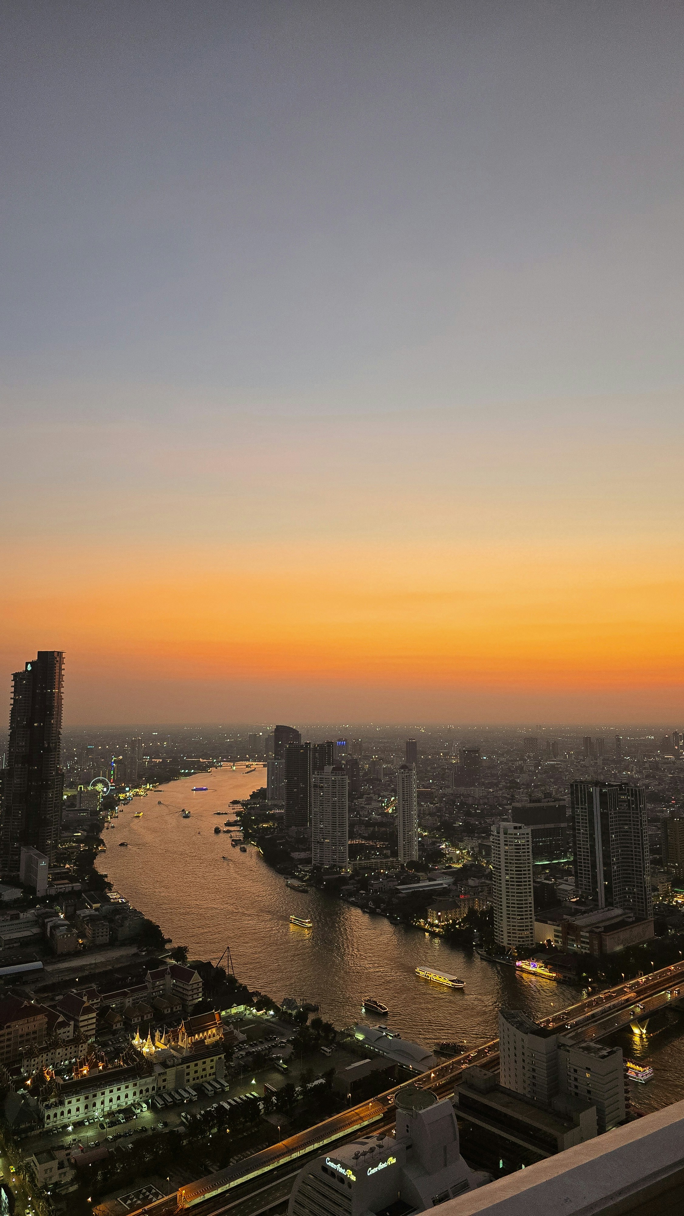 Cityscape with river at sunset with orange sky