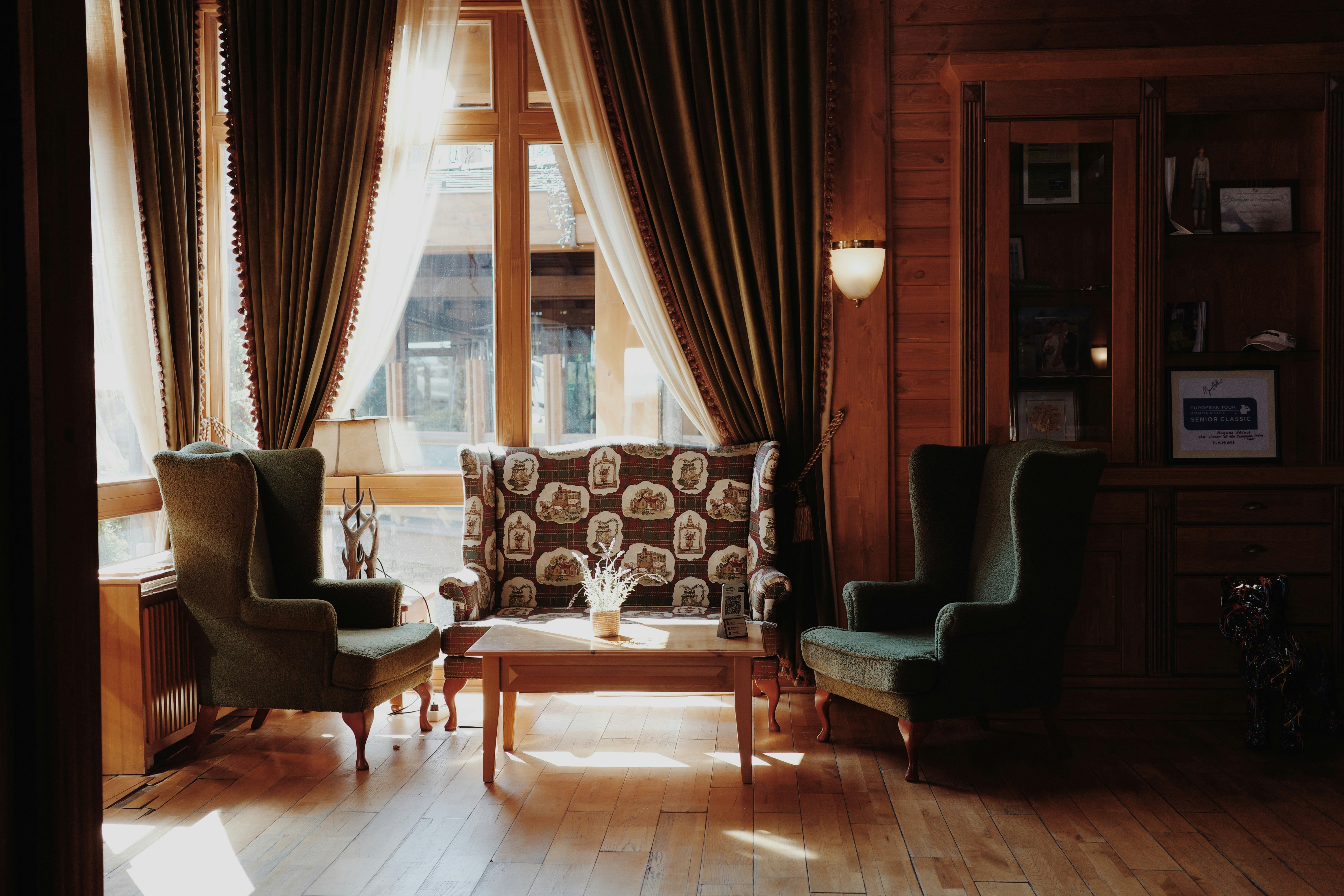 Cozy seating area with vintage chairs and patterned sofa.