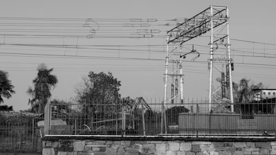 Overhead power lines and a metal tower structure.