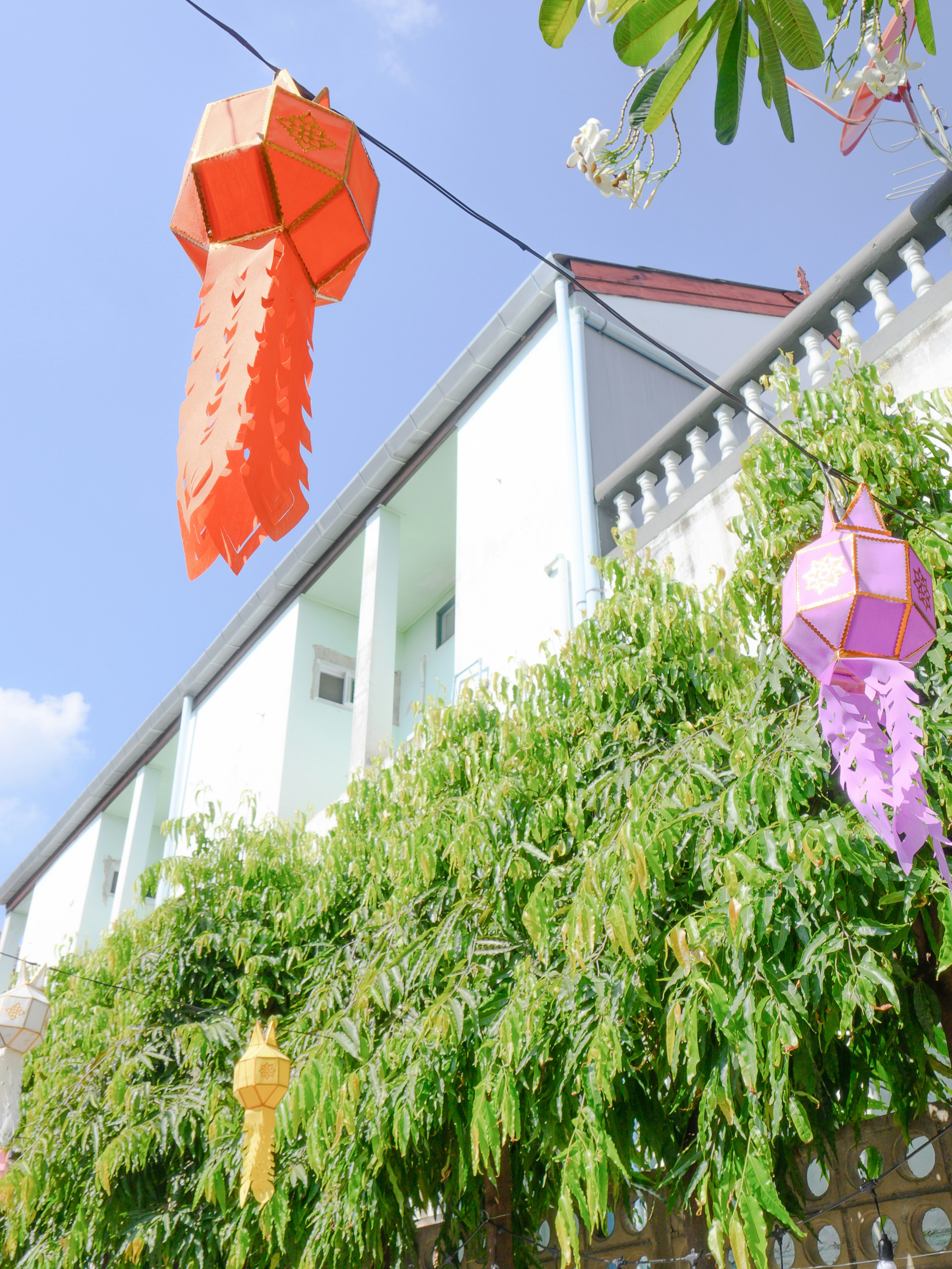 Hanging paper lanterns in front of a building.