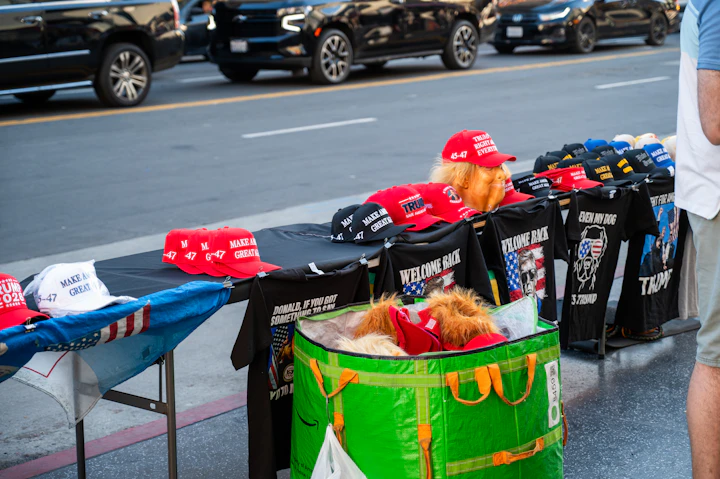 Merchandise stall with hats and shirts displayed on tables