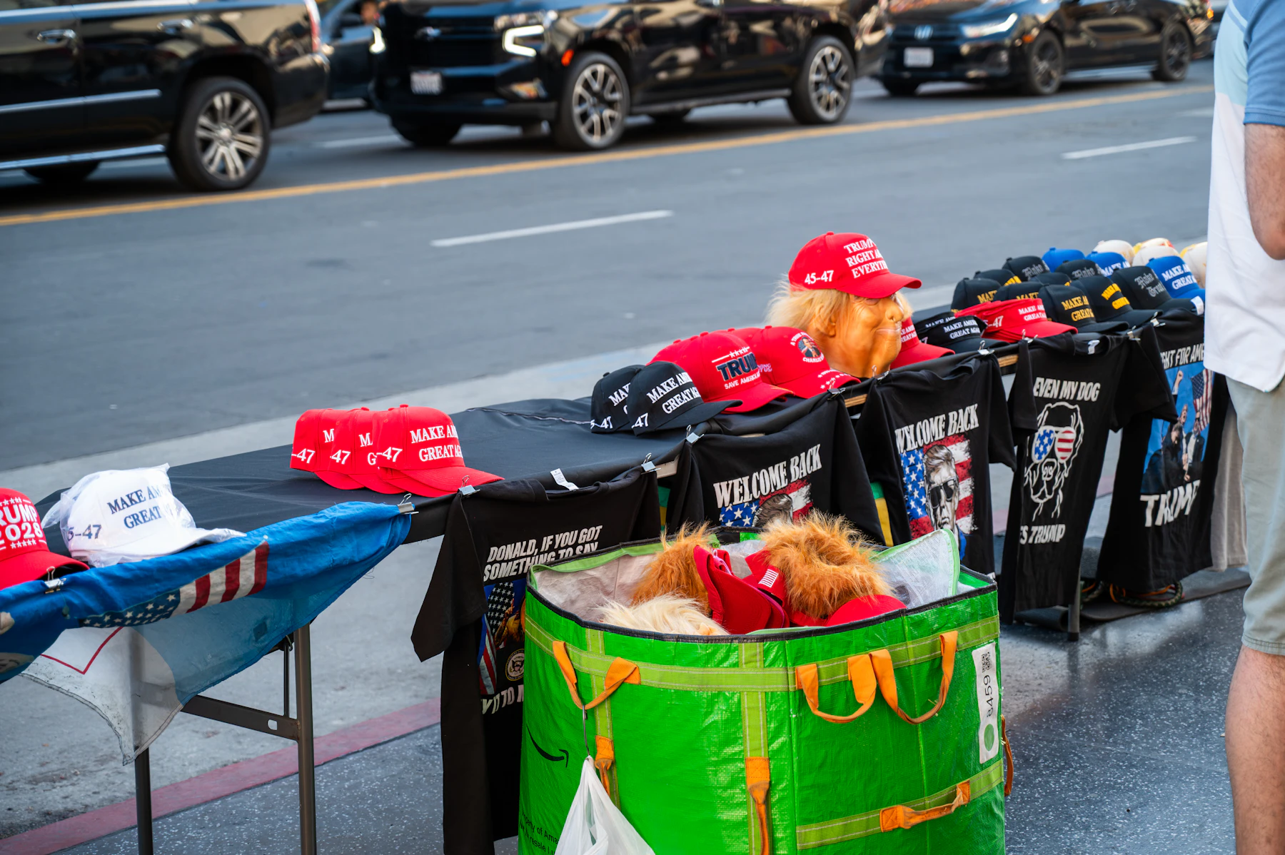 Merchandise stall with hats and shirts displayed on tables