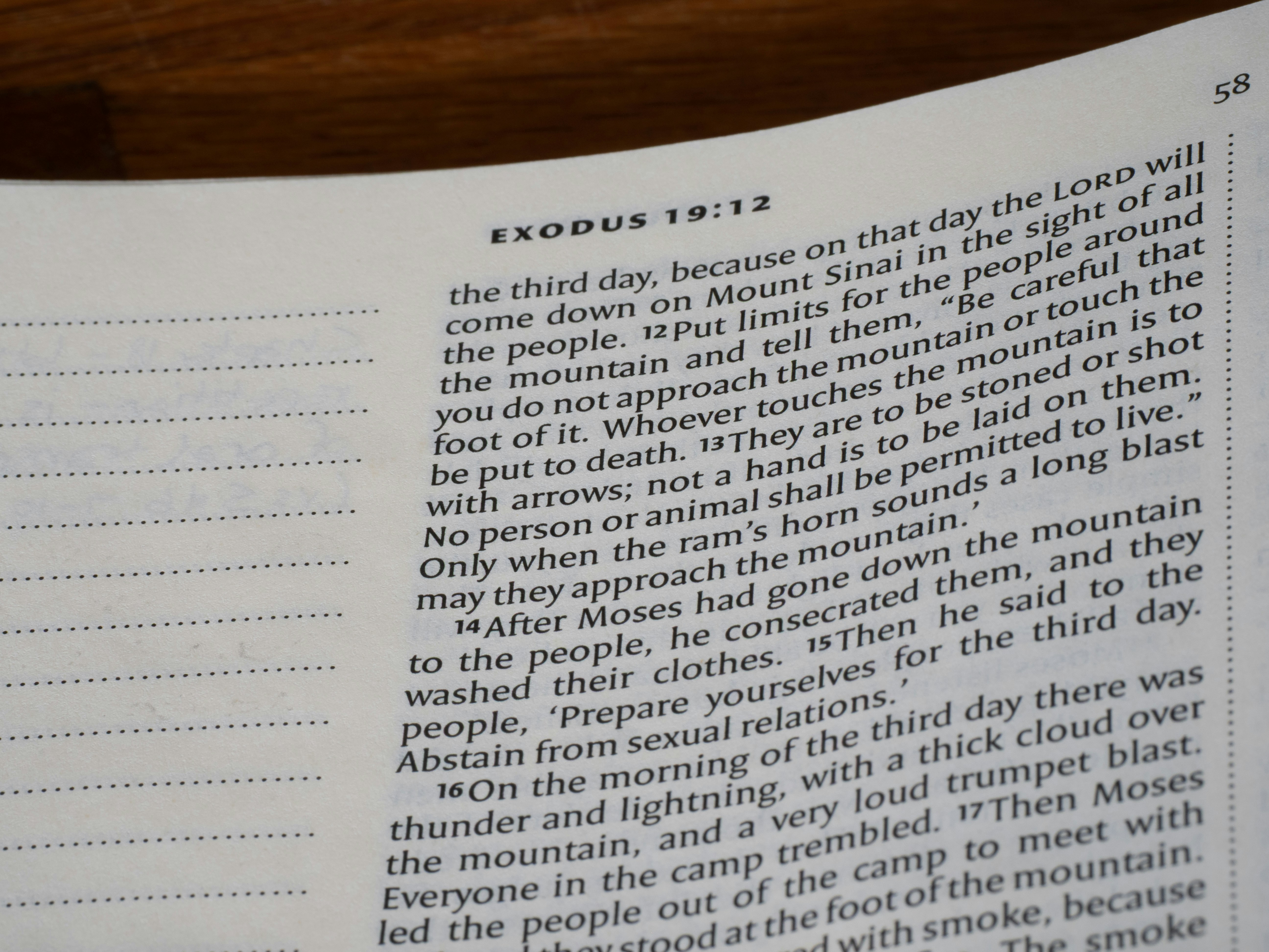 Close-up of exodus 19:12 text in a book.