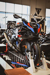 A black sport motorcycle with red and blue accents