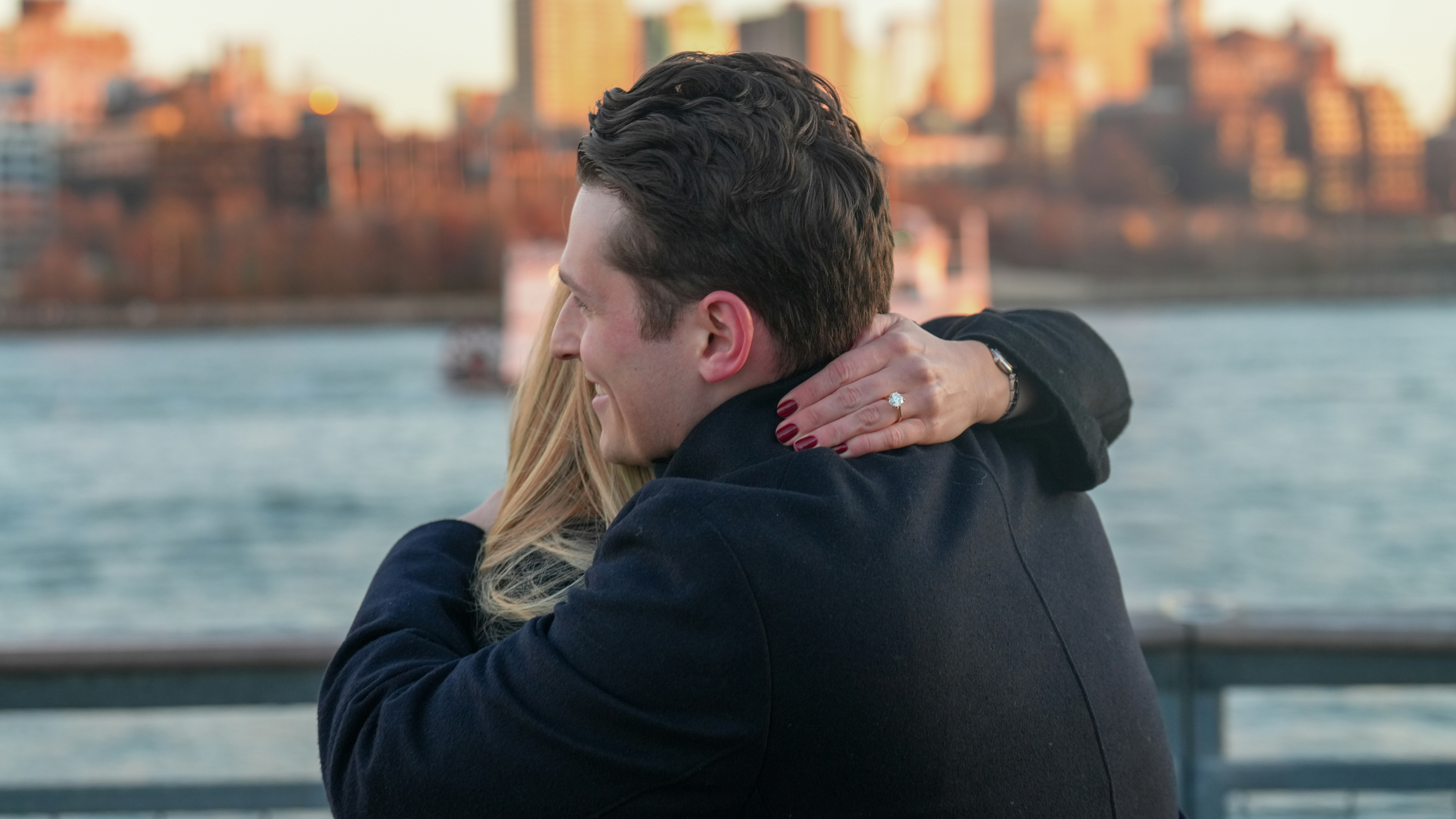 Couple hugging with city skyline in background