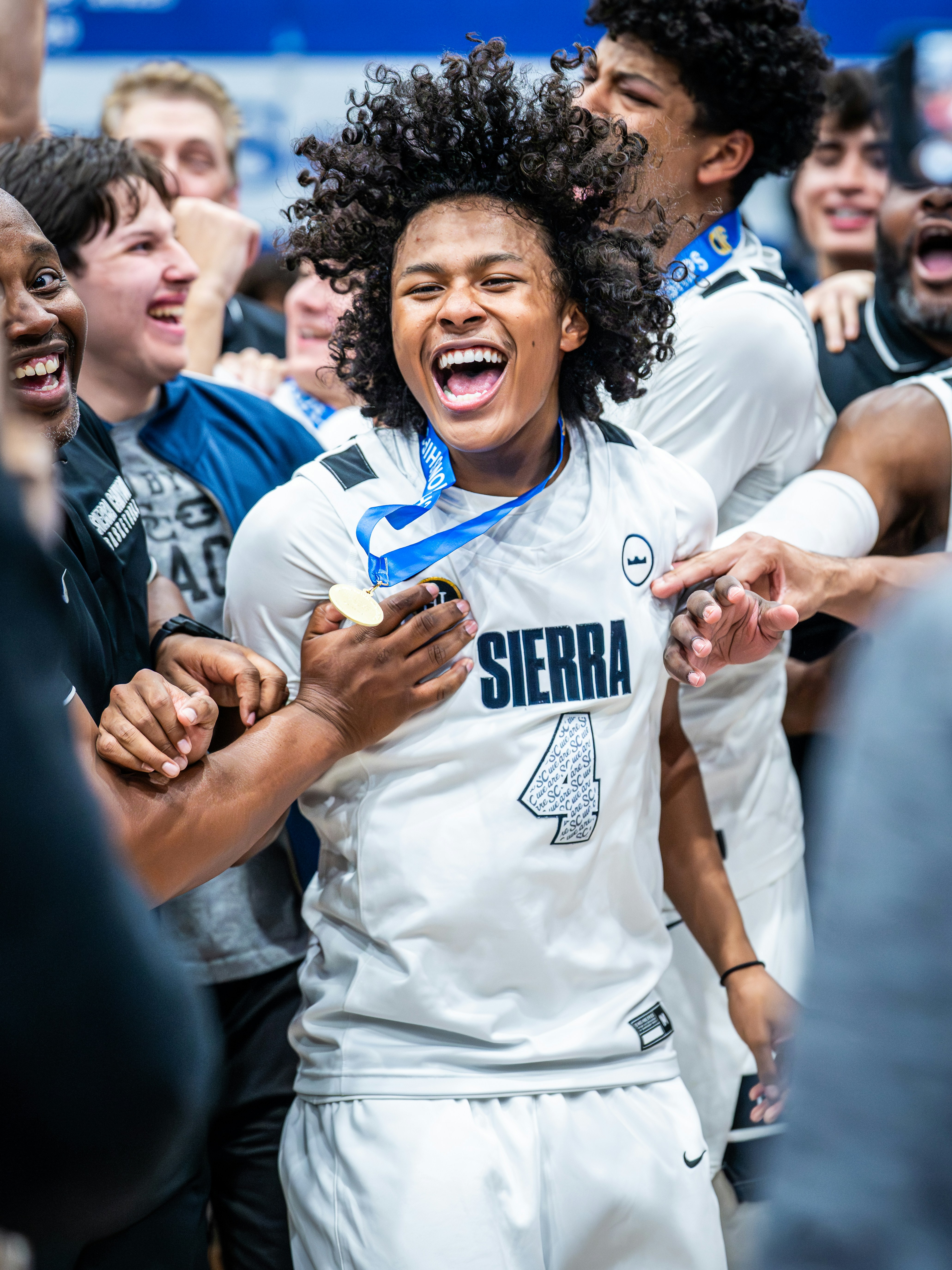 Young basketball player celebrates winning with teammates