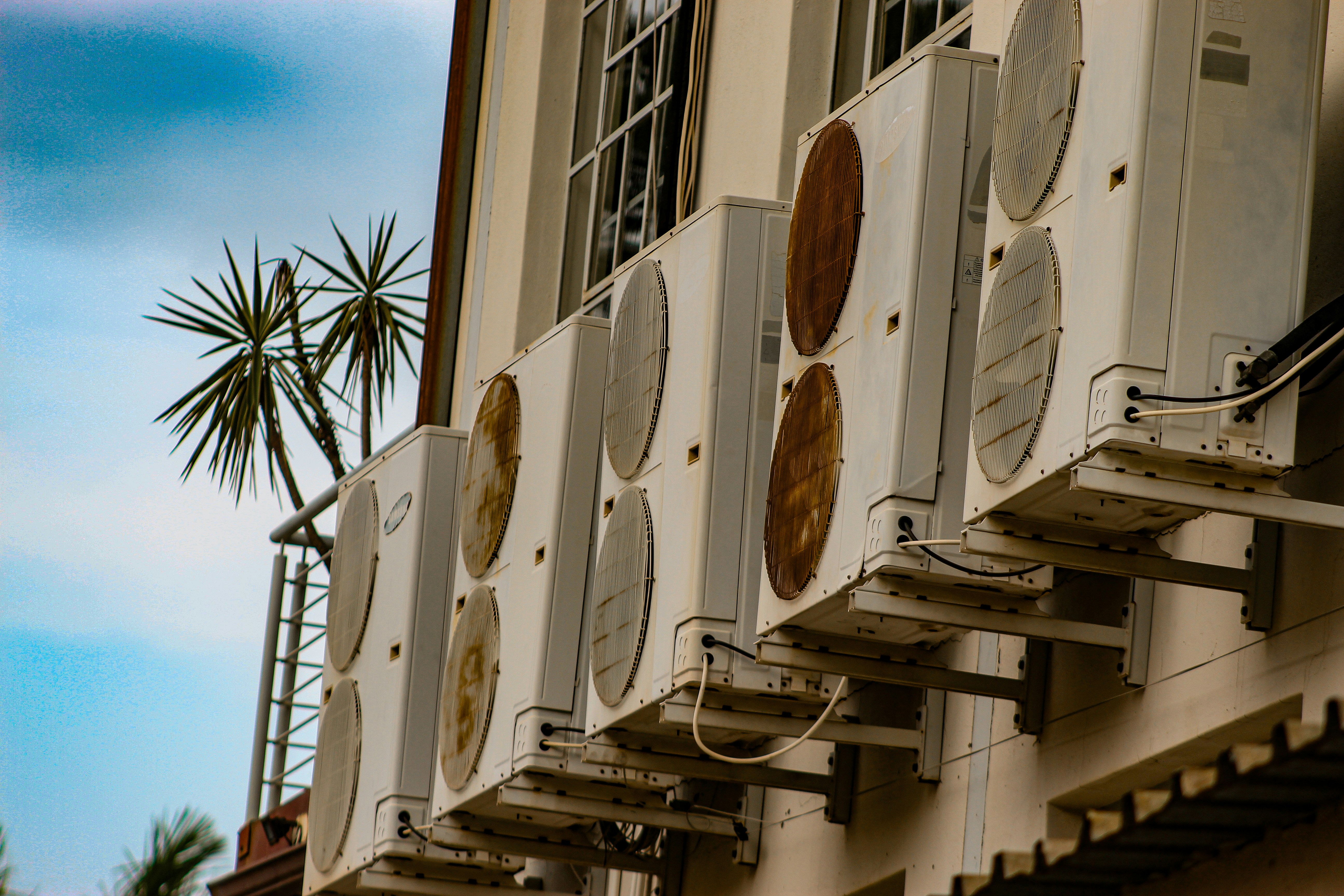 Multiple air conditioning units mounted on a building.