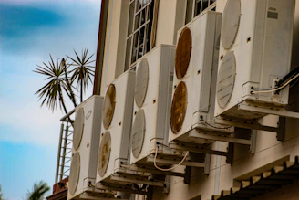 Multiple air conditioning units mounted on a building.