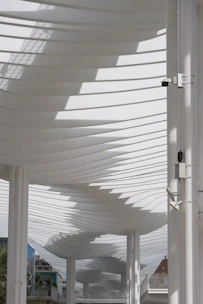 Modern white architectural structure with curved rooflines