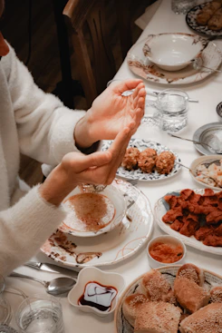 Hands clasped over a meal before eating