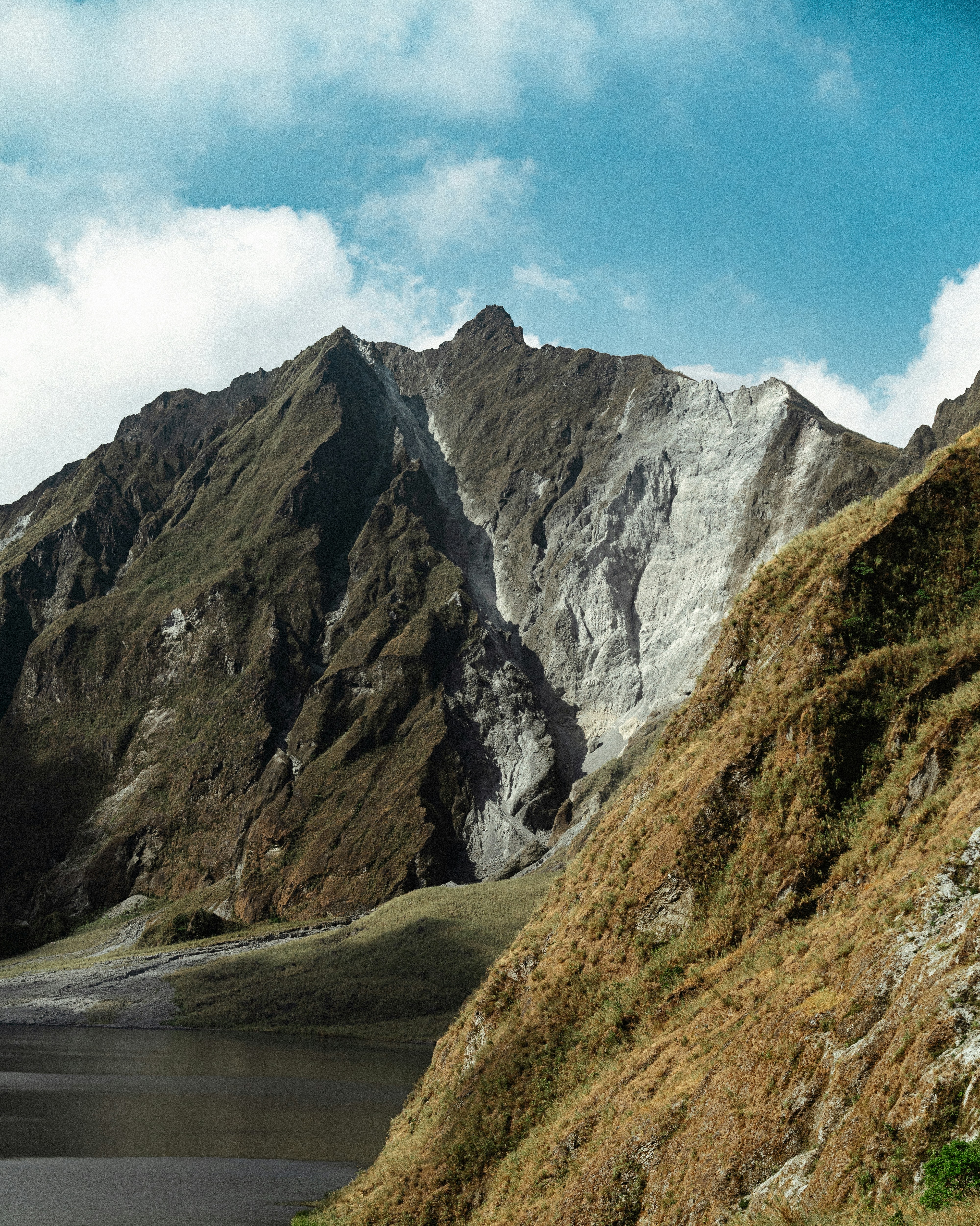 Rugged mountain slopes with a dark lake below