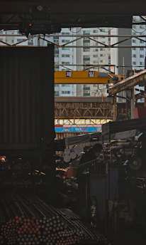 Industrial setting with stacked metal rods and a crane