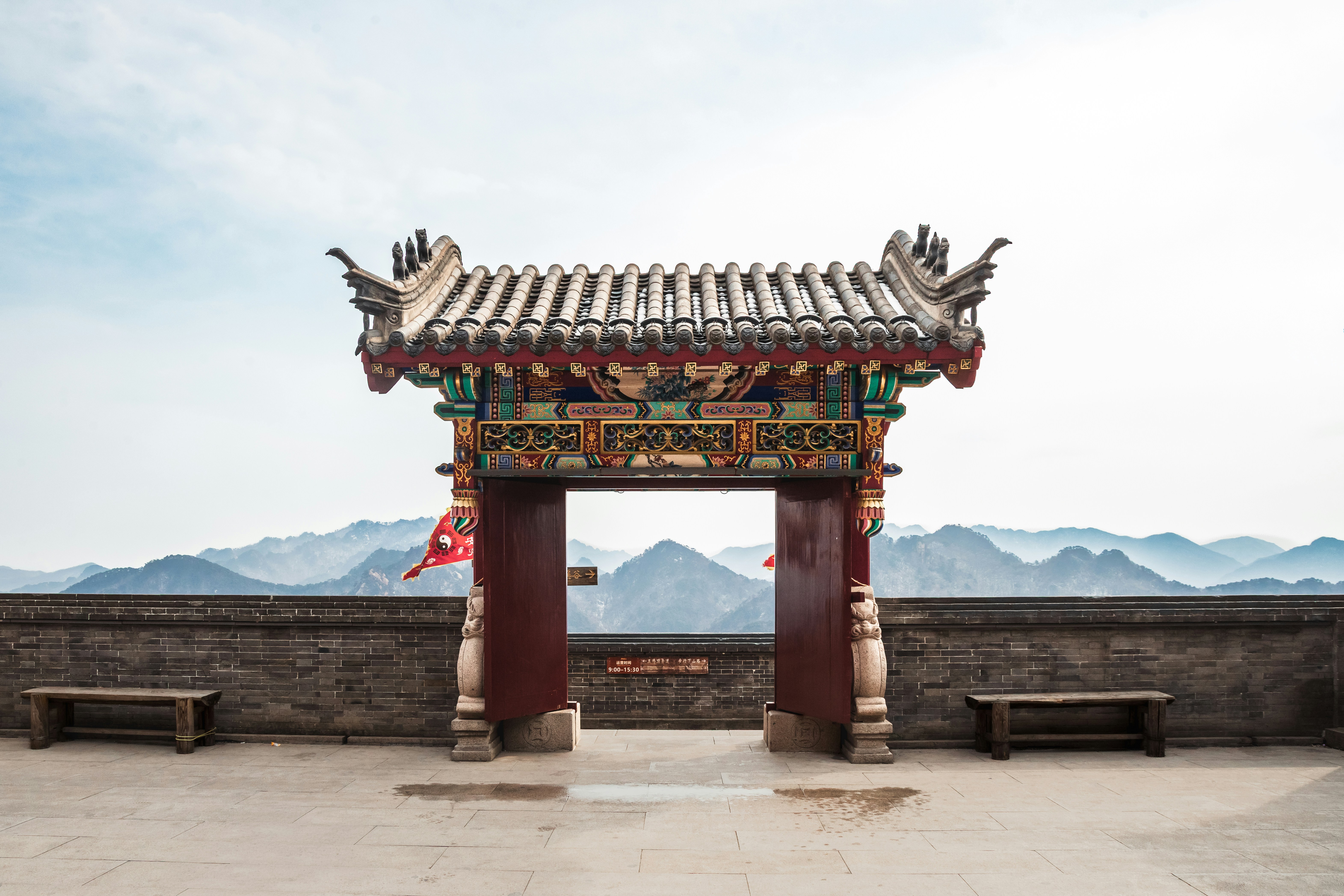 Puerta tradicional china ornamentada con fondo de montaña