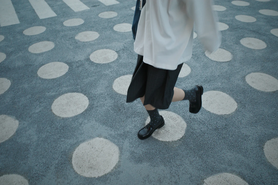 Child wearing school shoes while moving through a real daily routine