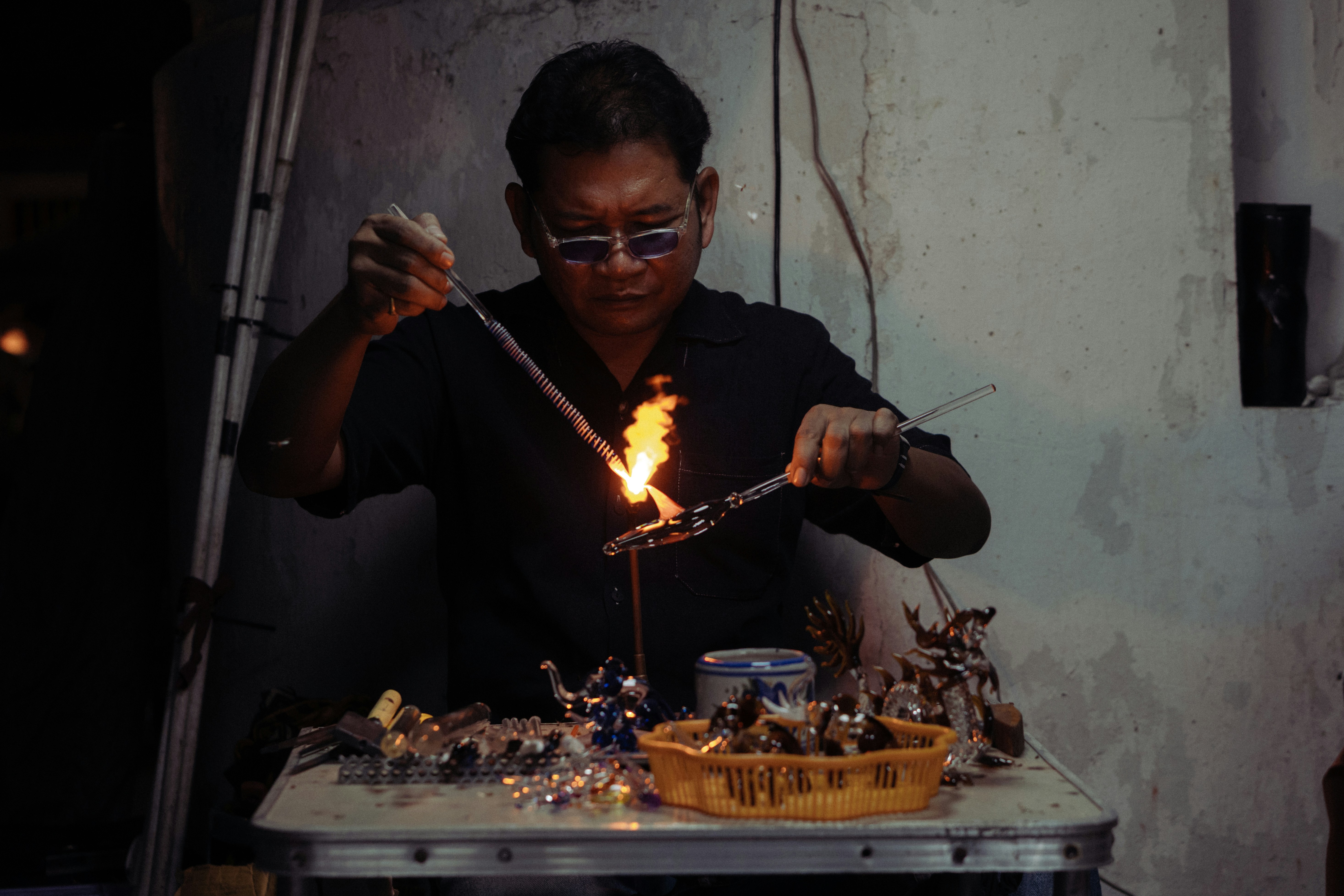 Man working with hot glass and flame