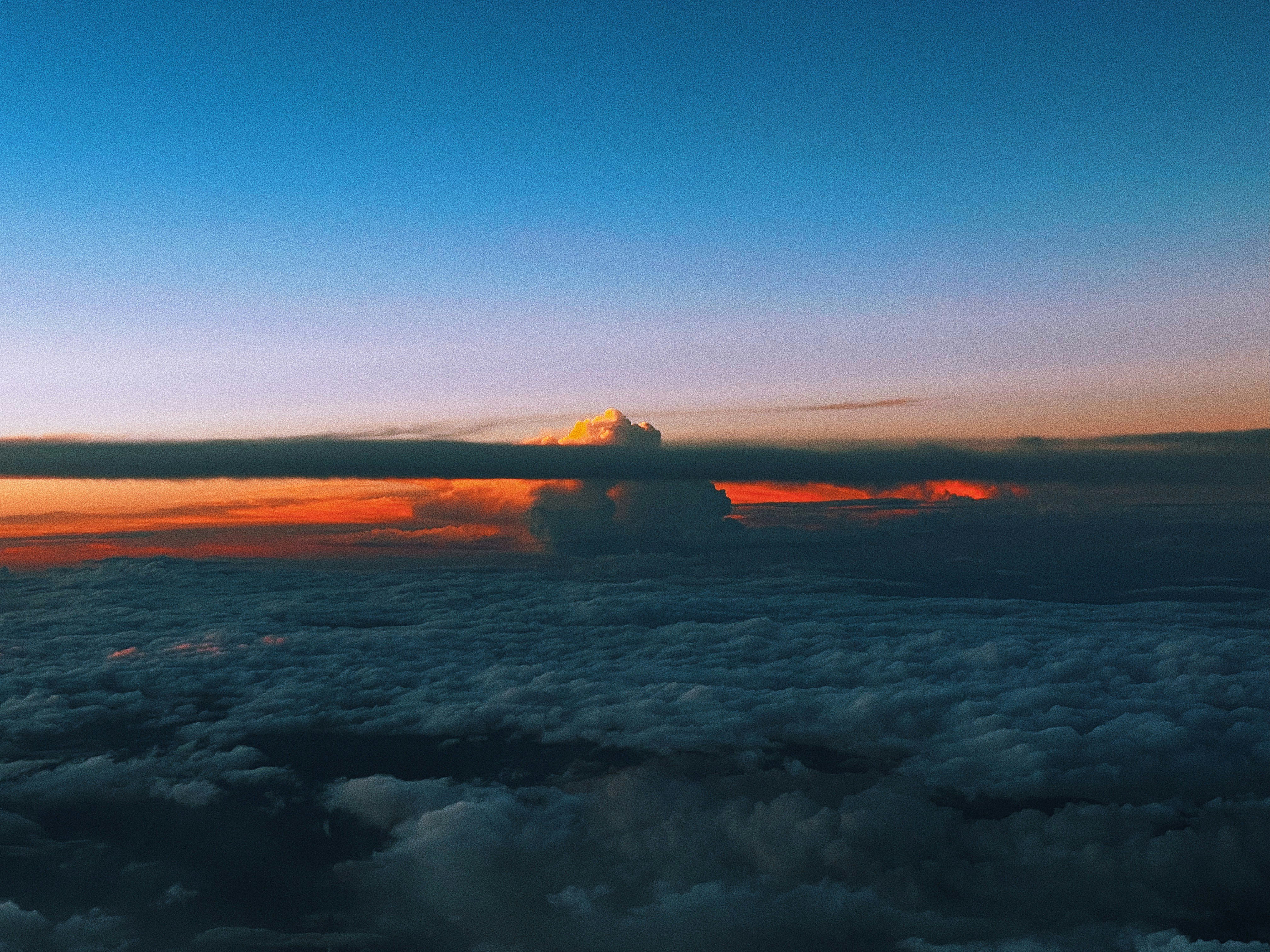 Sunrise over a sea of clouds from airplane window
