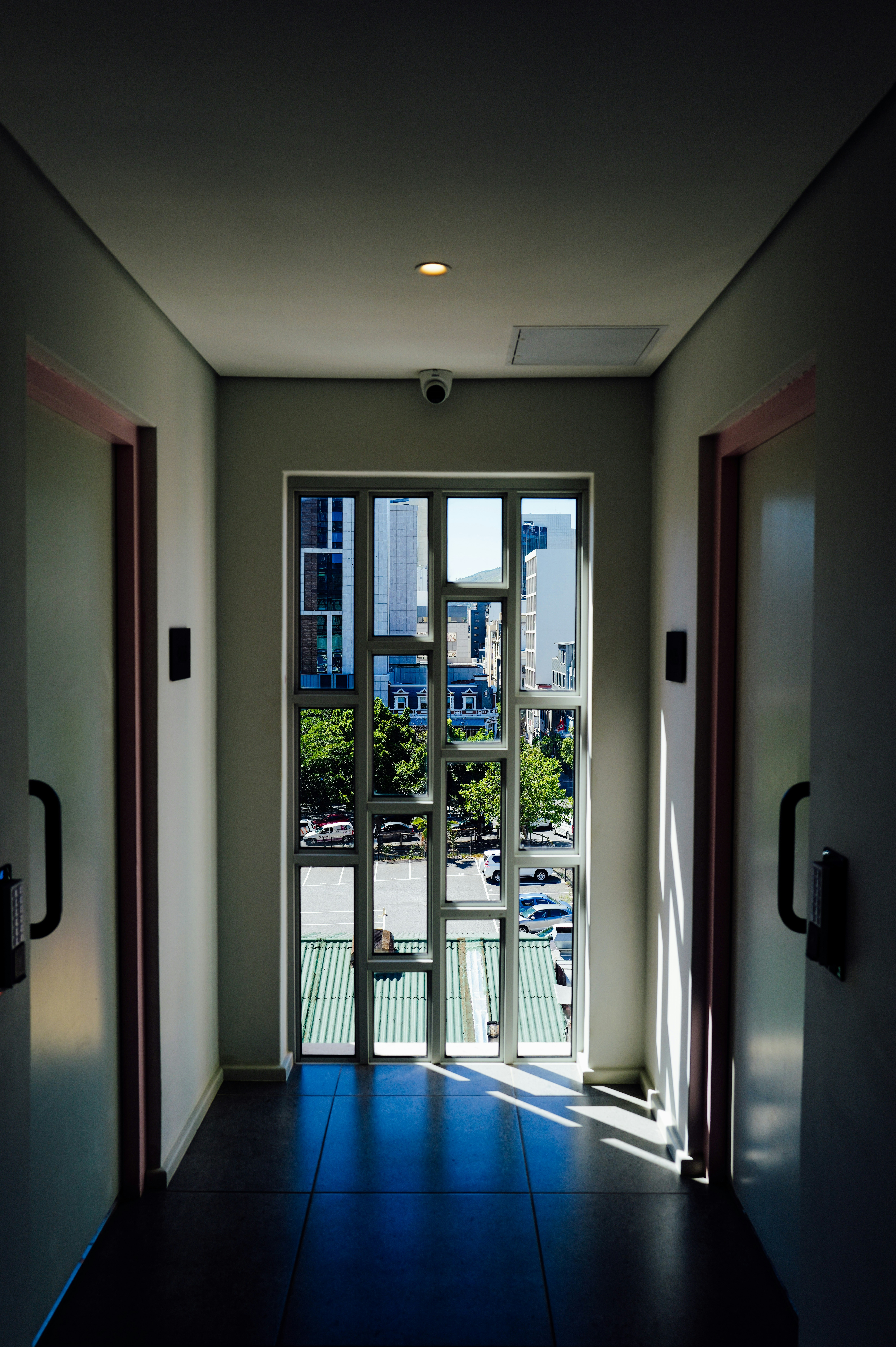 Modern hallway with a window overlooking buildings and cityscape photo ...