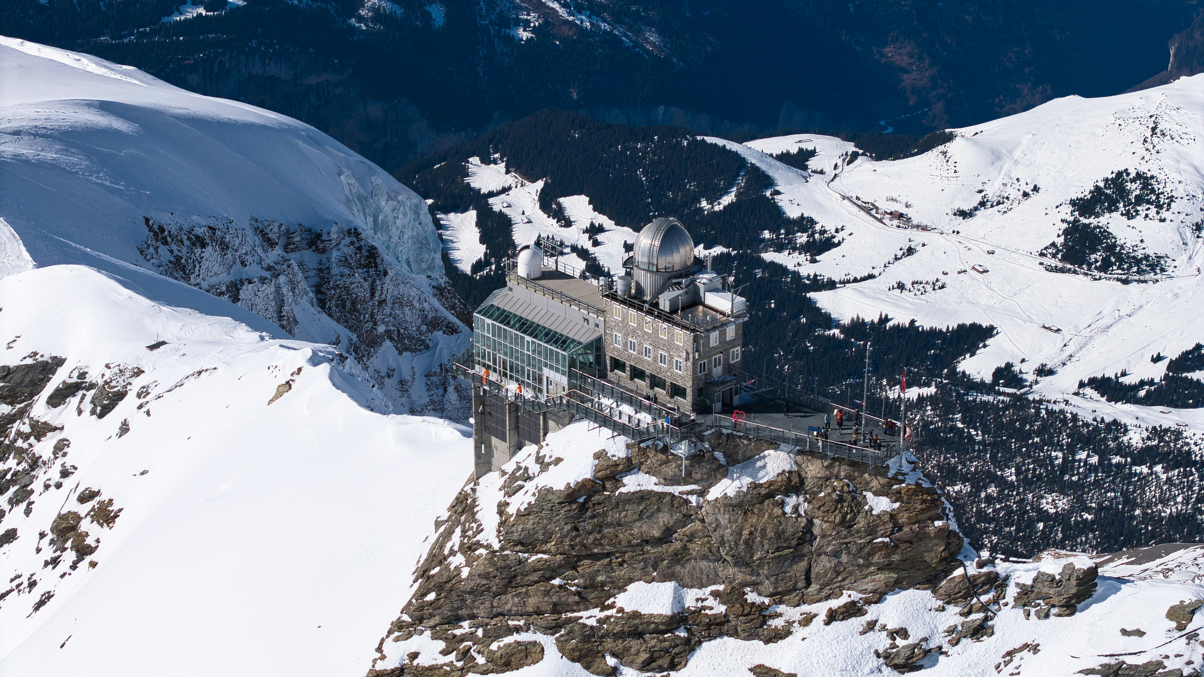Modern building on snowy mountain peak