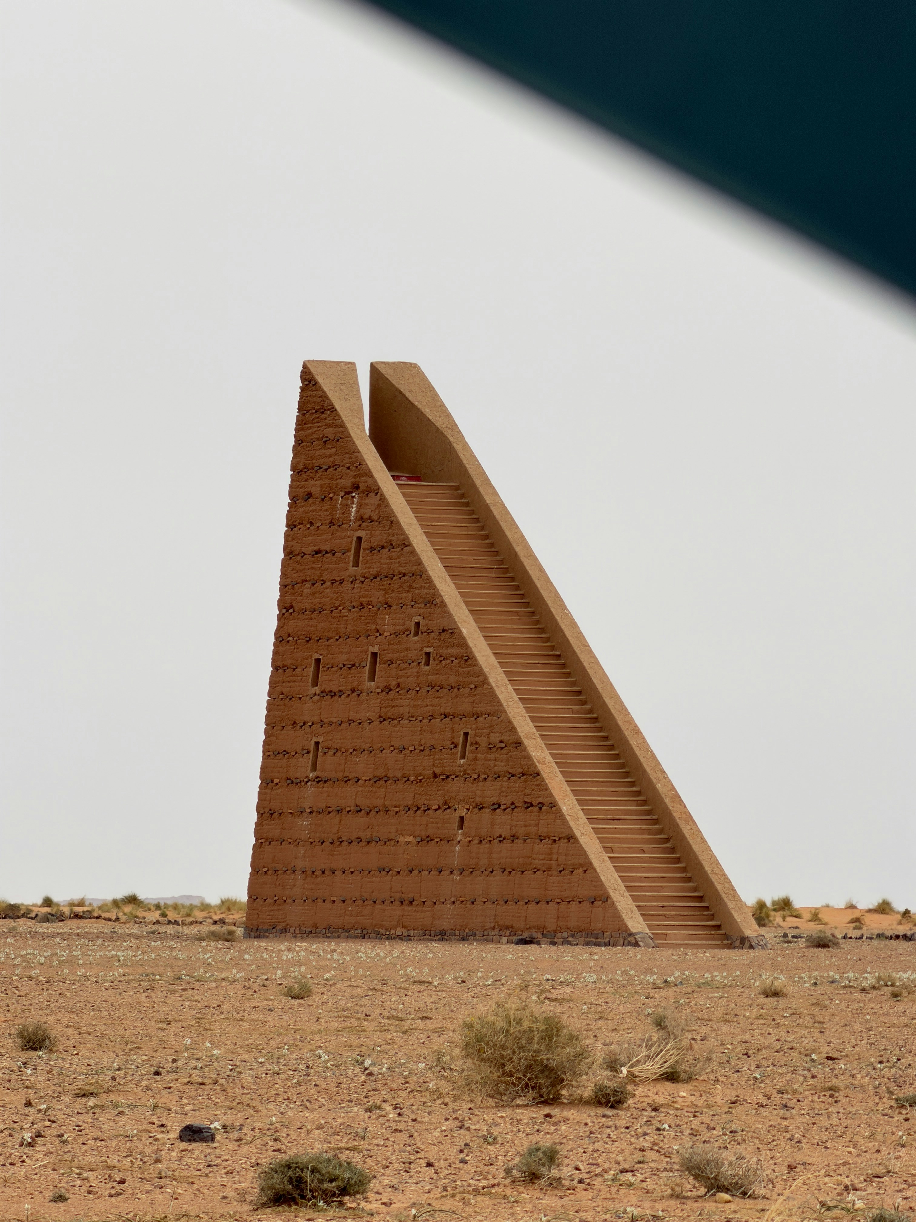 A pyramid-like structure with stairs in a desert