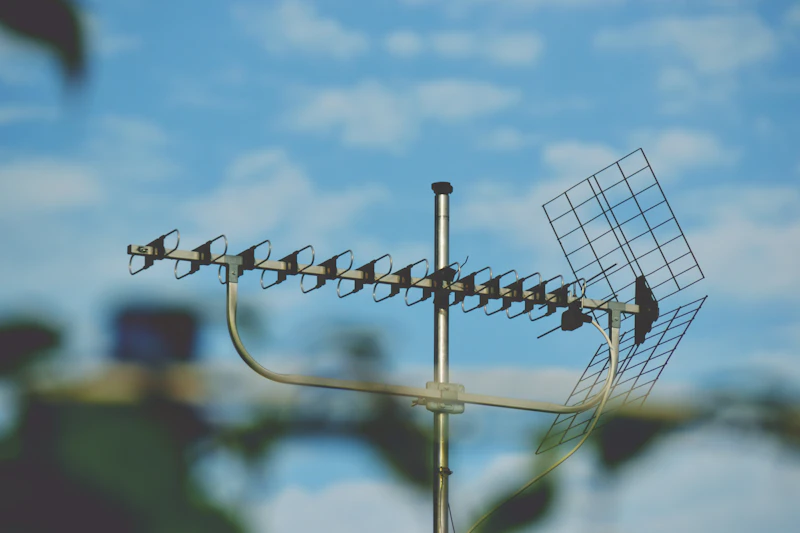 An outdoor TV antenna against a blue sky