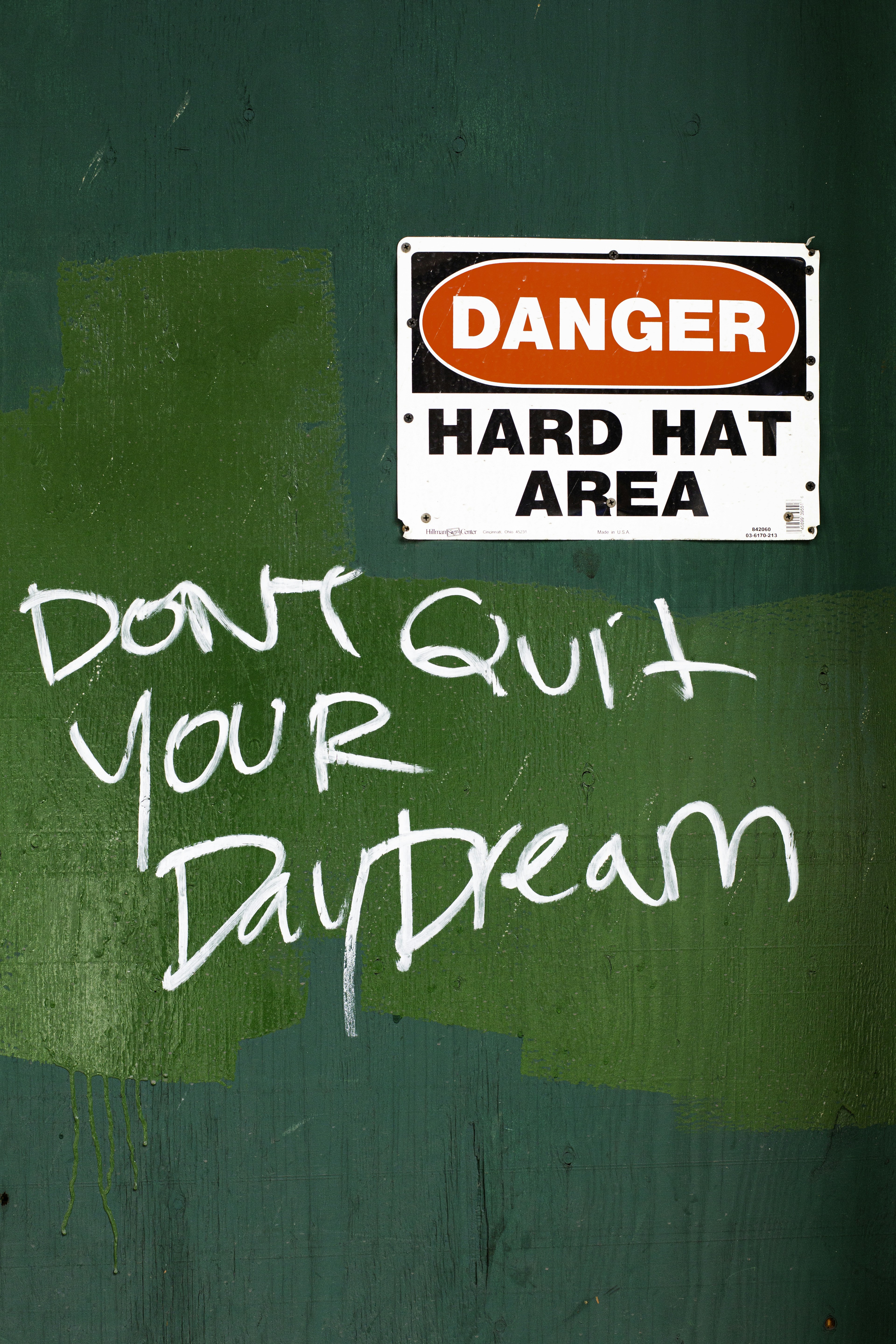 Danger hard hat area sign with graffiti