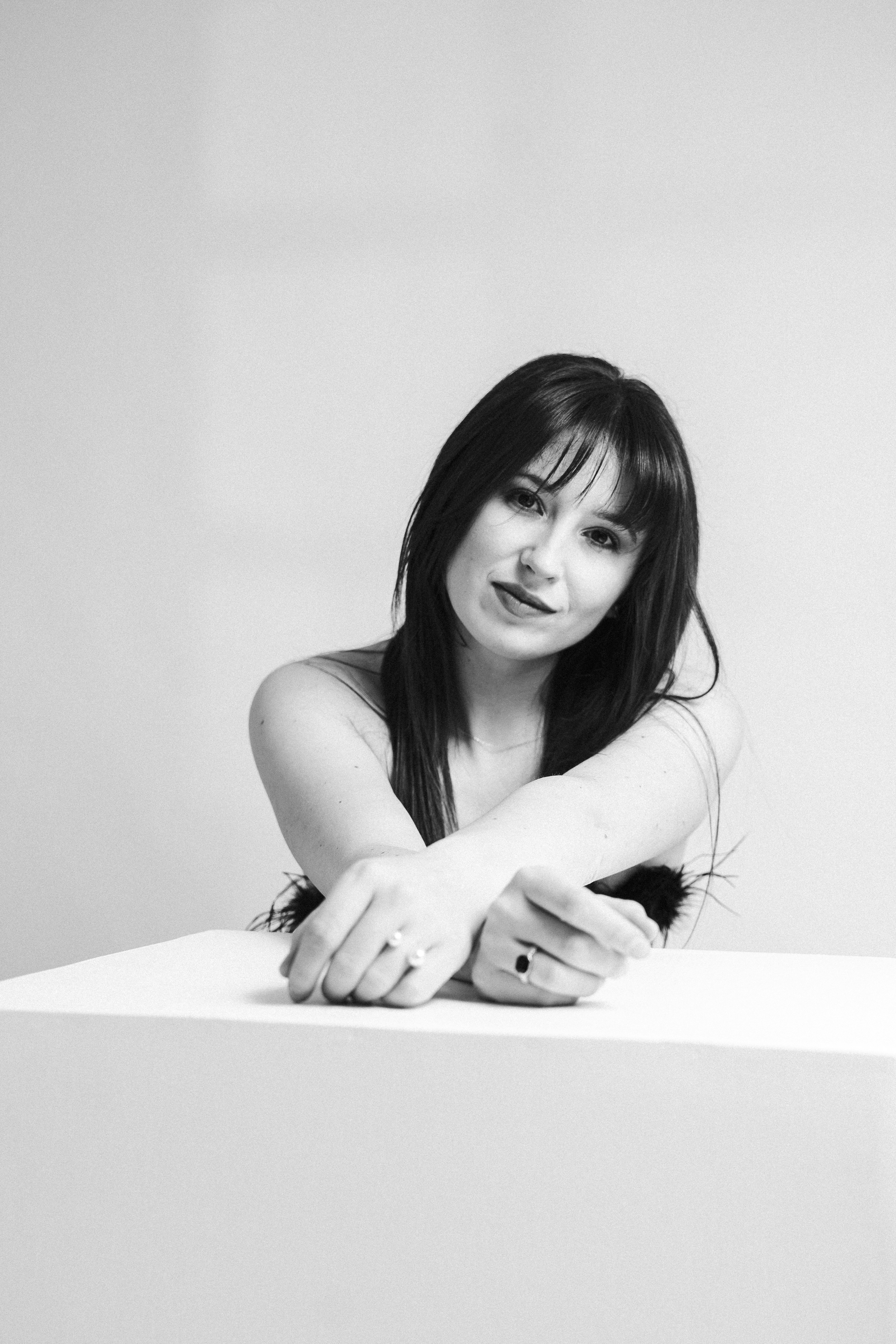 A black and white studio portrait of a woman.