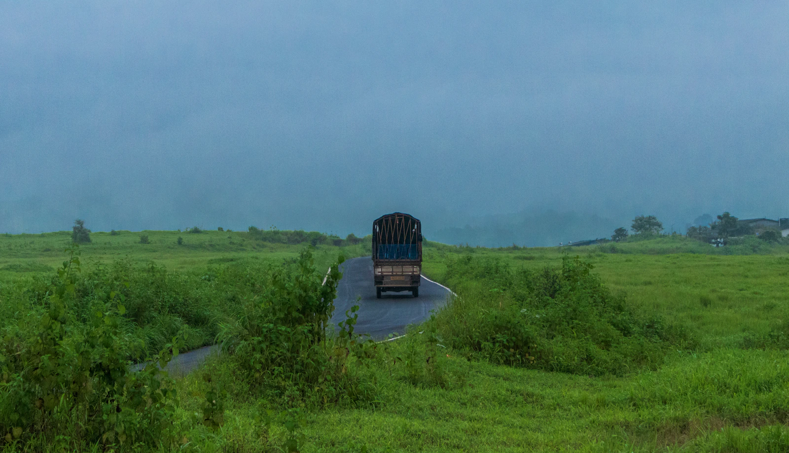 SHIFT truck on a winding highway through green fields