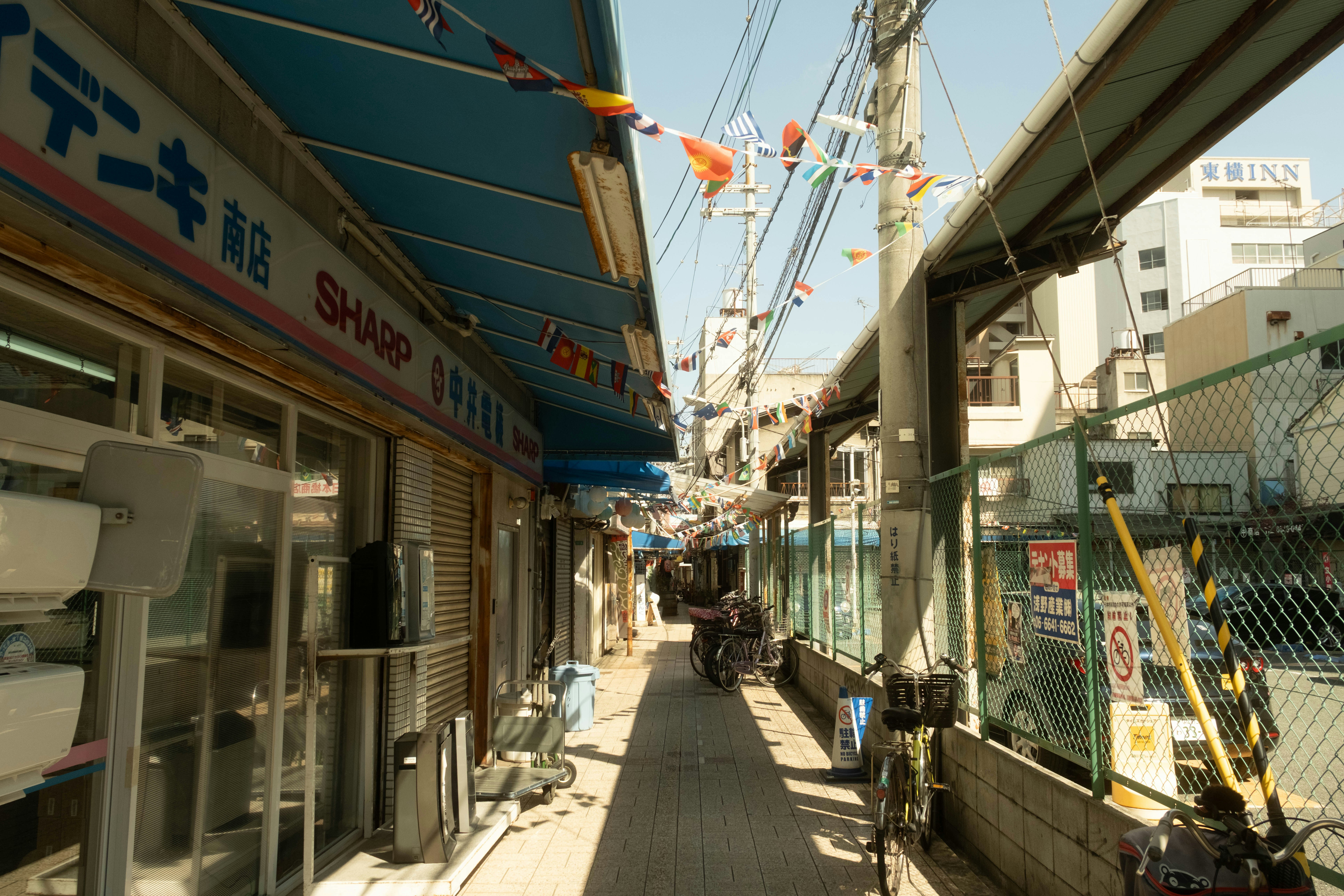 Narrow street with shops and overhead wires