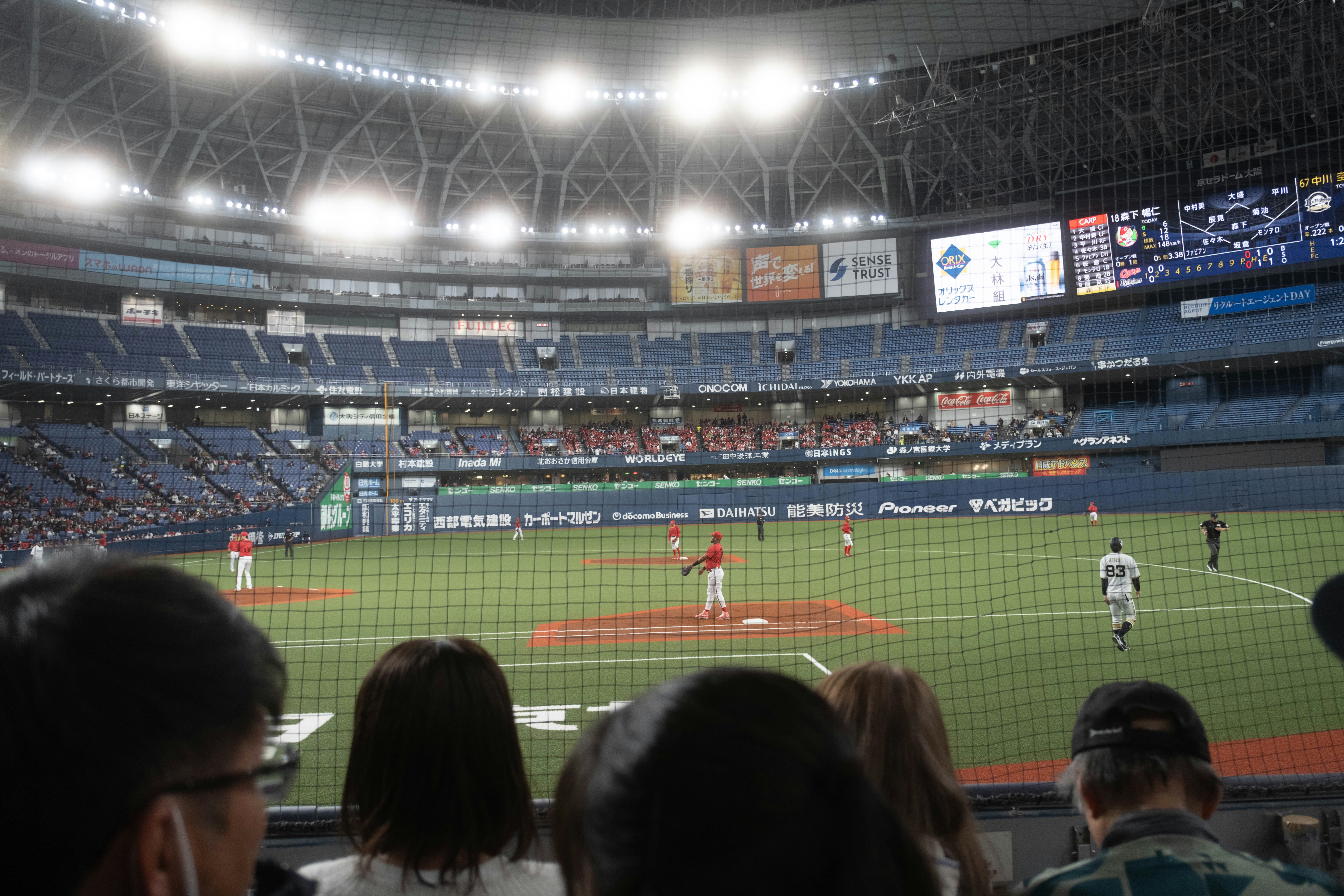 Baseball game in a stadium with spectators watching.