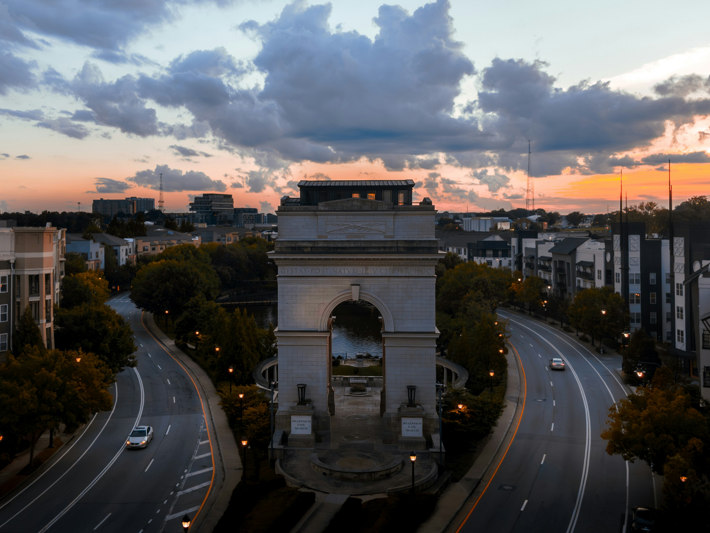 Grand arch monument with roads at sunset