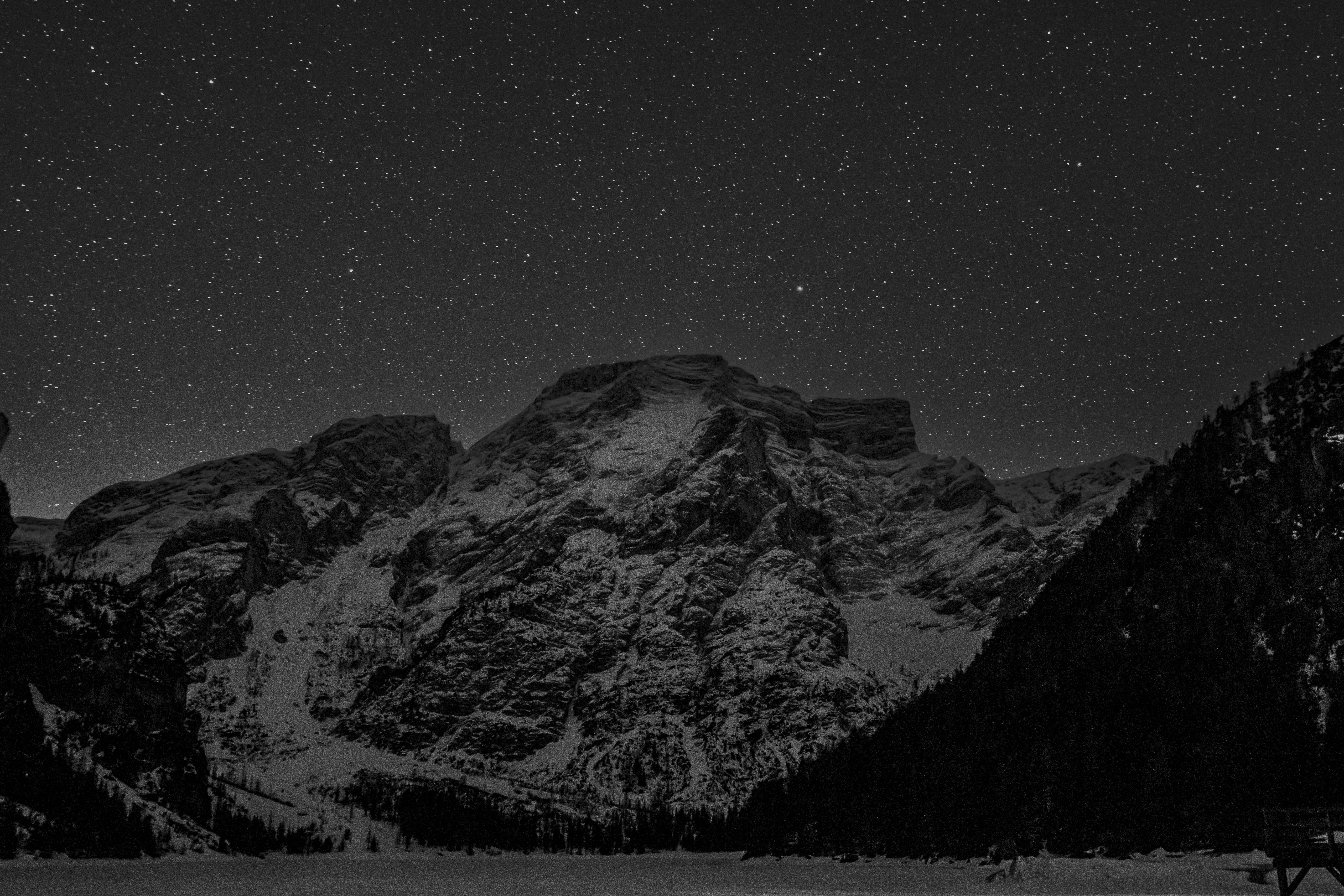 Snowy mountains under a starry night sky