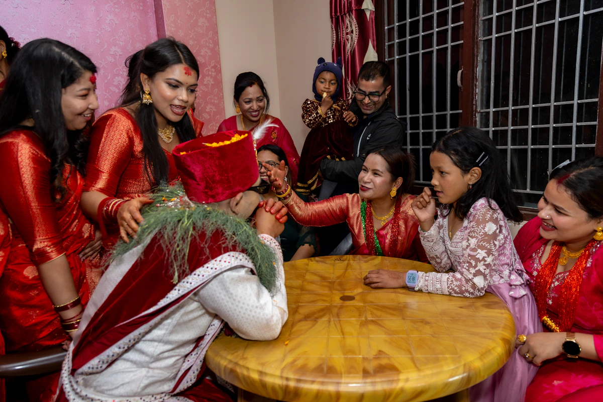 A group of people in traditional attire celebrating together around a table