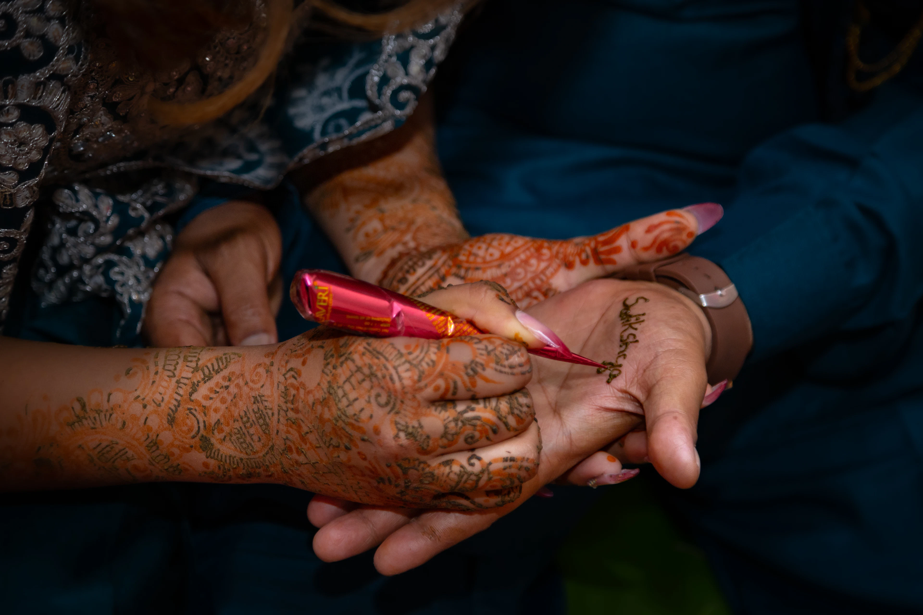 A henna design fading gradually over two weeks from deep maroon to faint tan