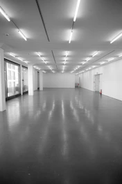 Empty, brightly lit exhibition hall with polished floor.
