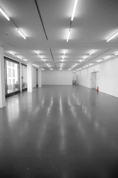 Empty, brightly lit exhibition hall with polished floor.