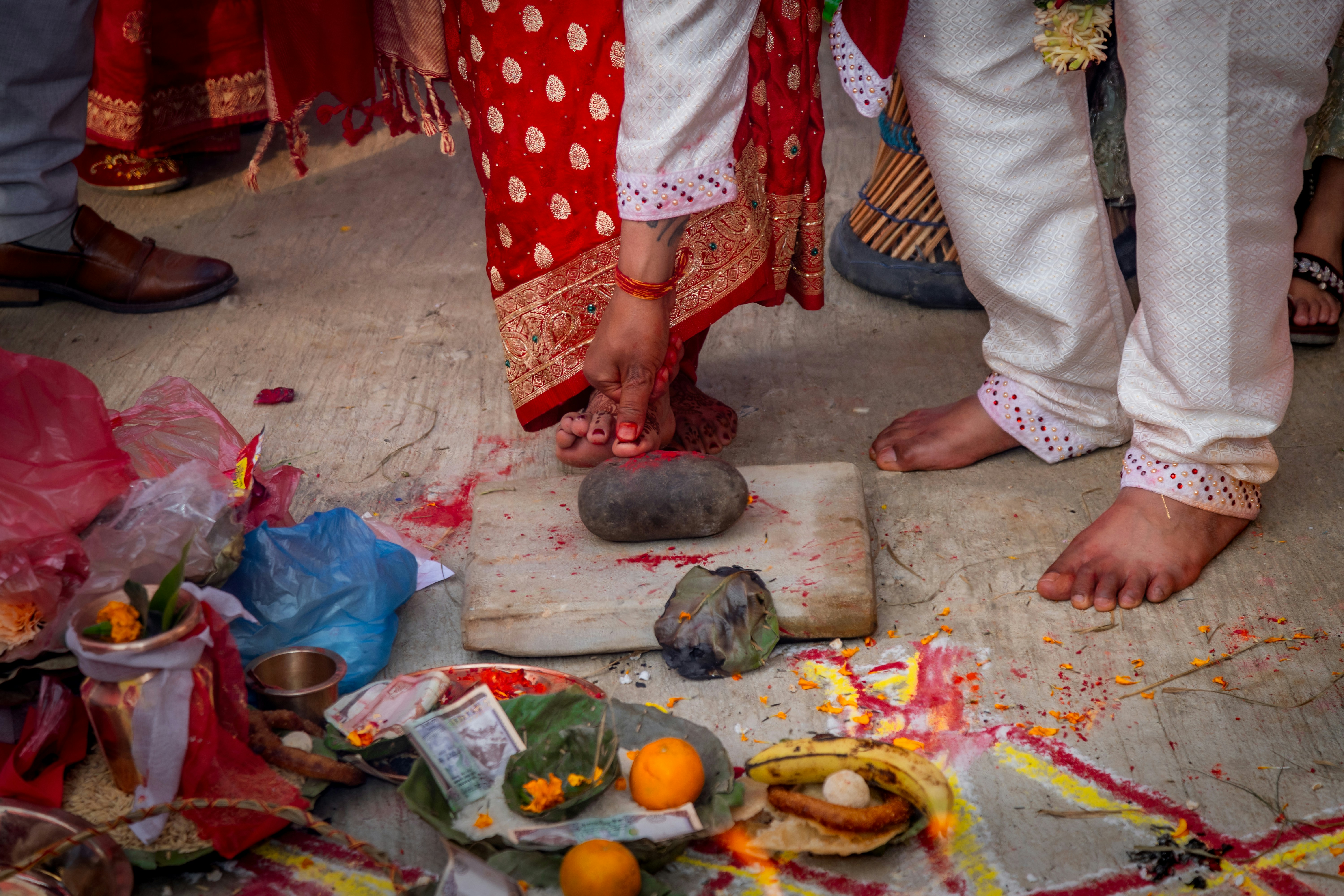 Bride and Groom at Mandap During Nepali Wedding | Traditional Ceremony Moment- During a Nepali wedding, the bride and groom sit together at the mandap, performing sacred rituals that symbolize their union. Surrounded by family, priests, and blessings, they participate in age-old traditions, exchanging vows and offerings. This ceremonial moment reflects Nepali culture, love, and the spiritual significance of marriage, creating lifelong memories
