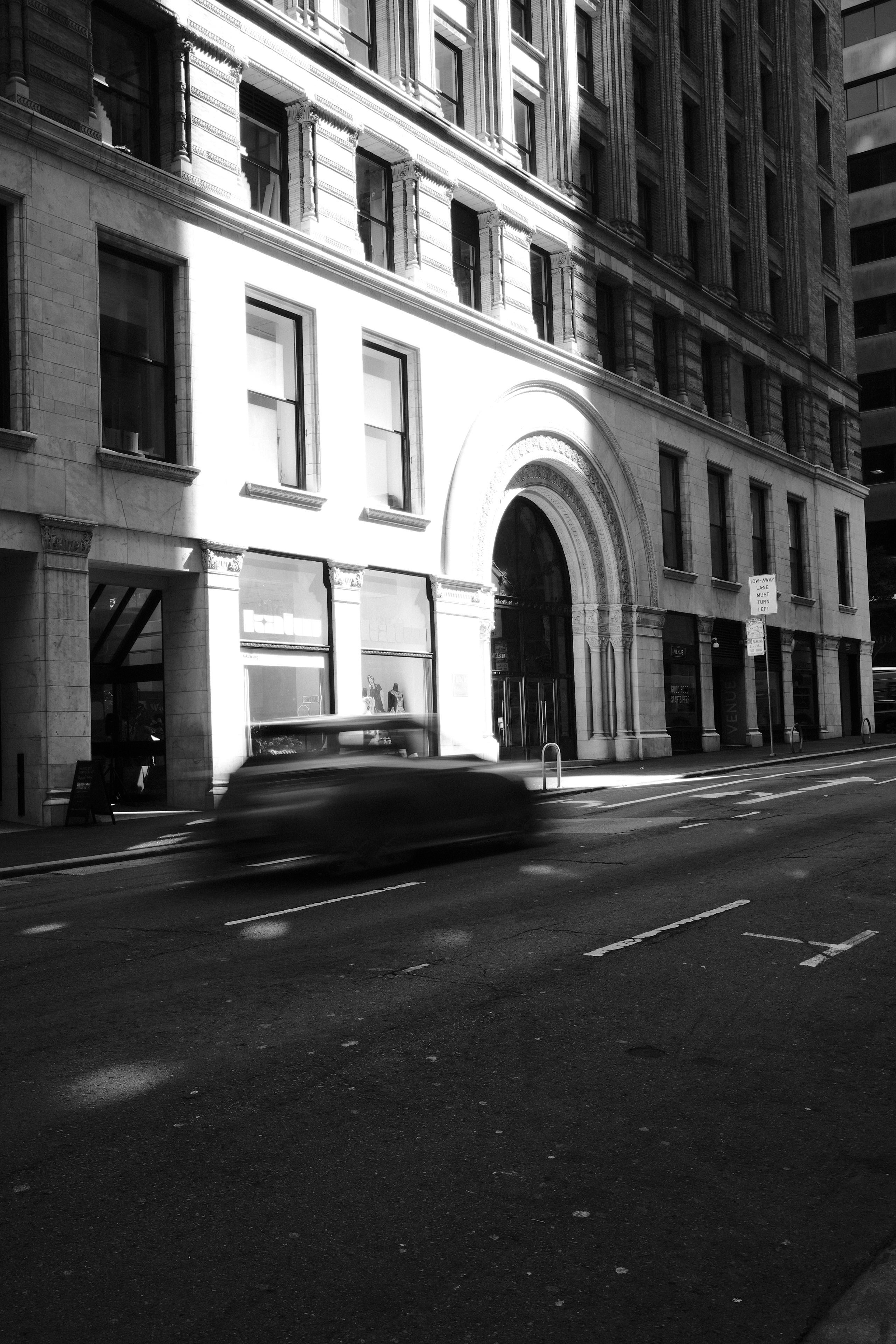 A car blurred by motion on a city street.