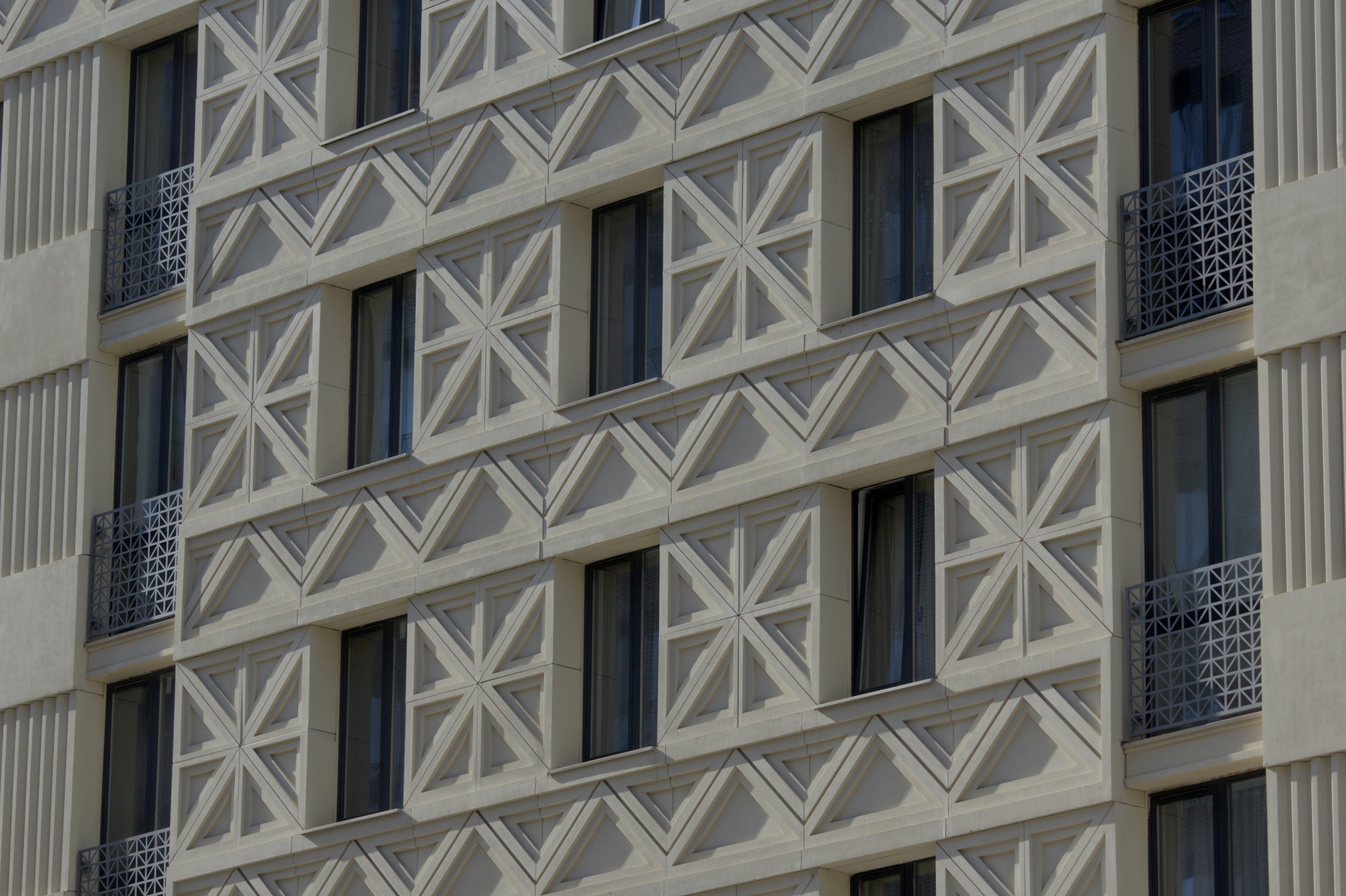 Modern building facade with geometric patterned concrete
